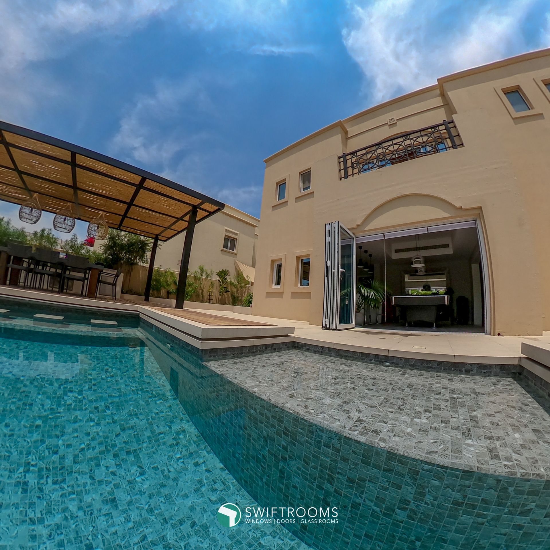 A large house with a swimming pool in front of it