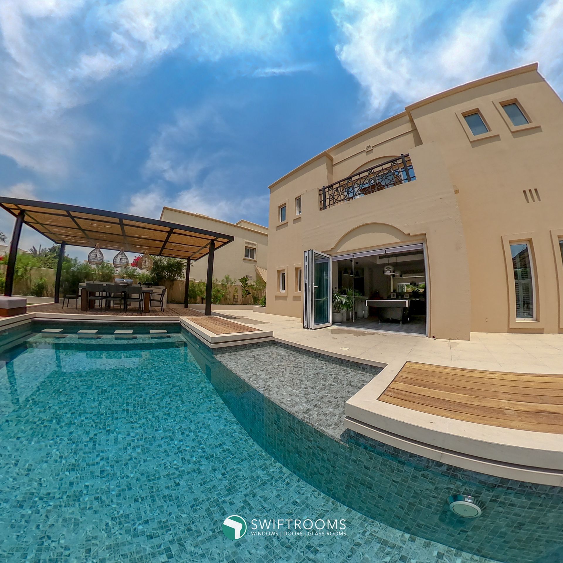 A large house with a swimming pool in front of it