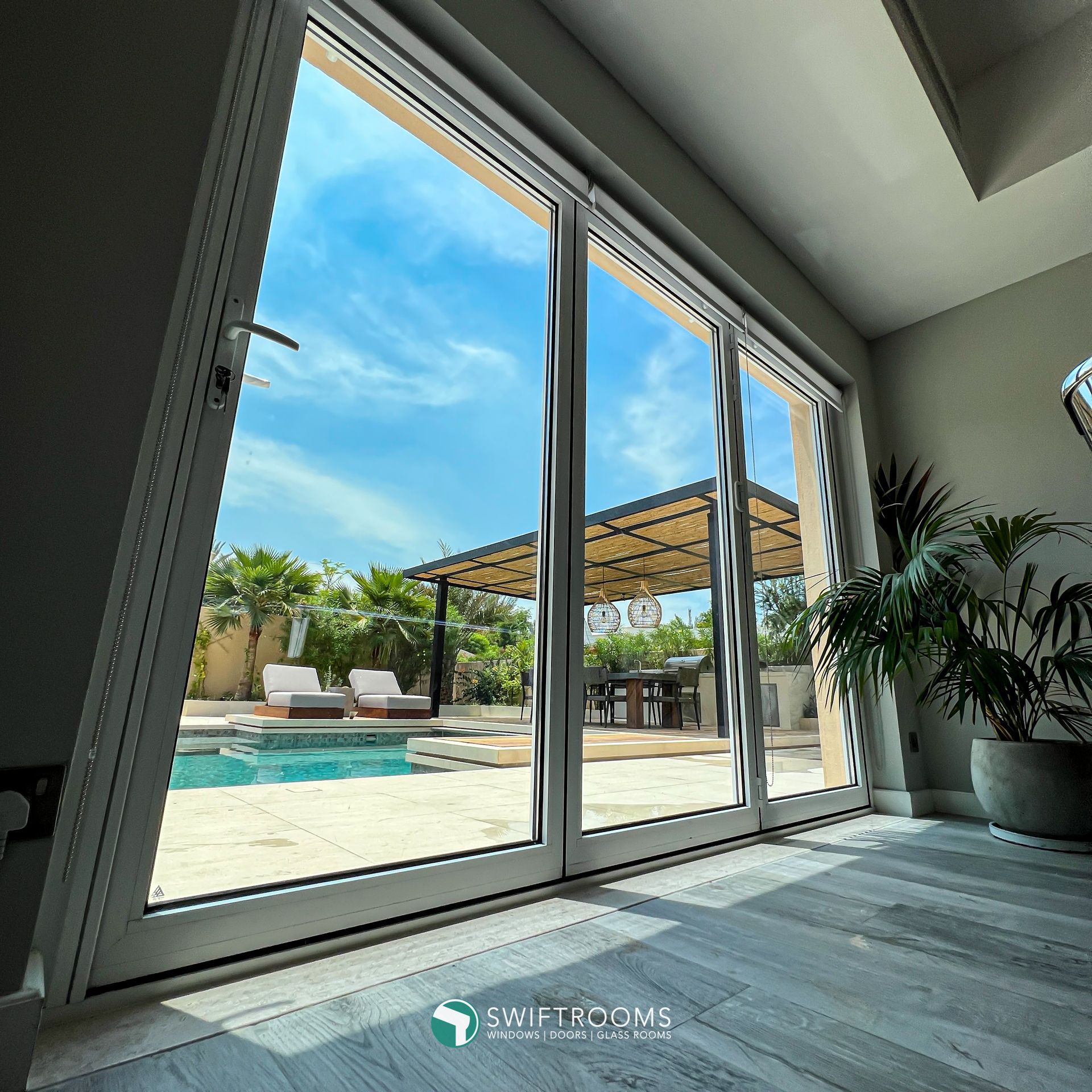 A sliding glass door with a view of a swimming pool