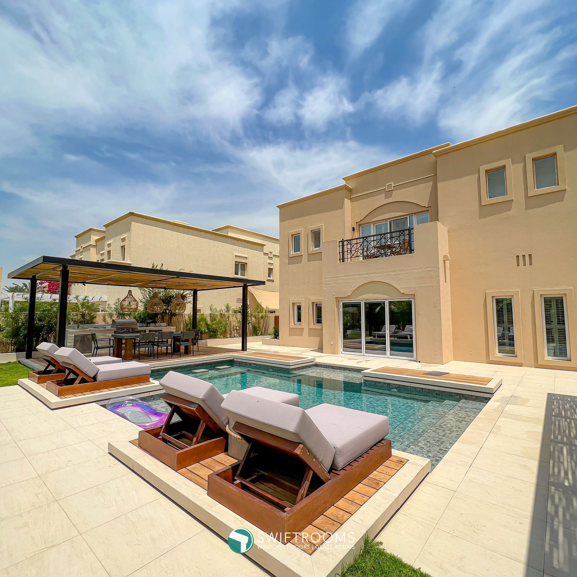 A large house with a large swimming pool in front of it