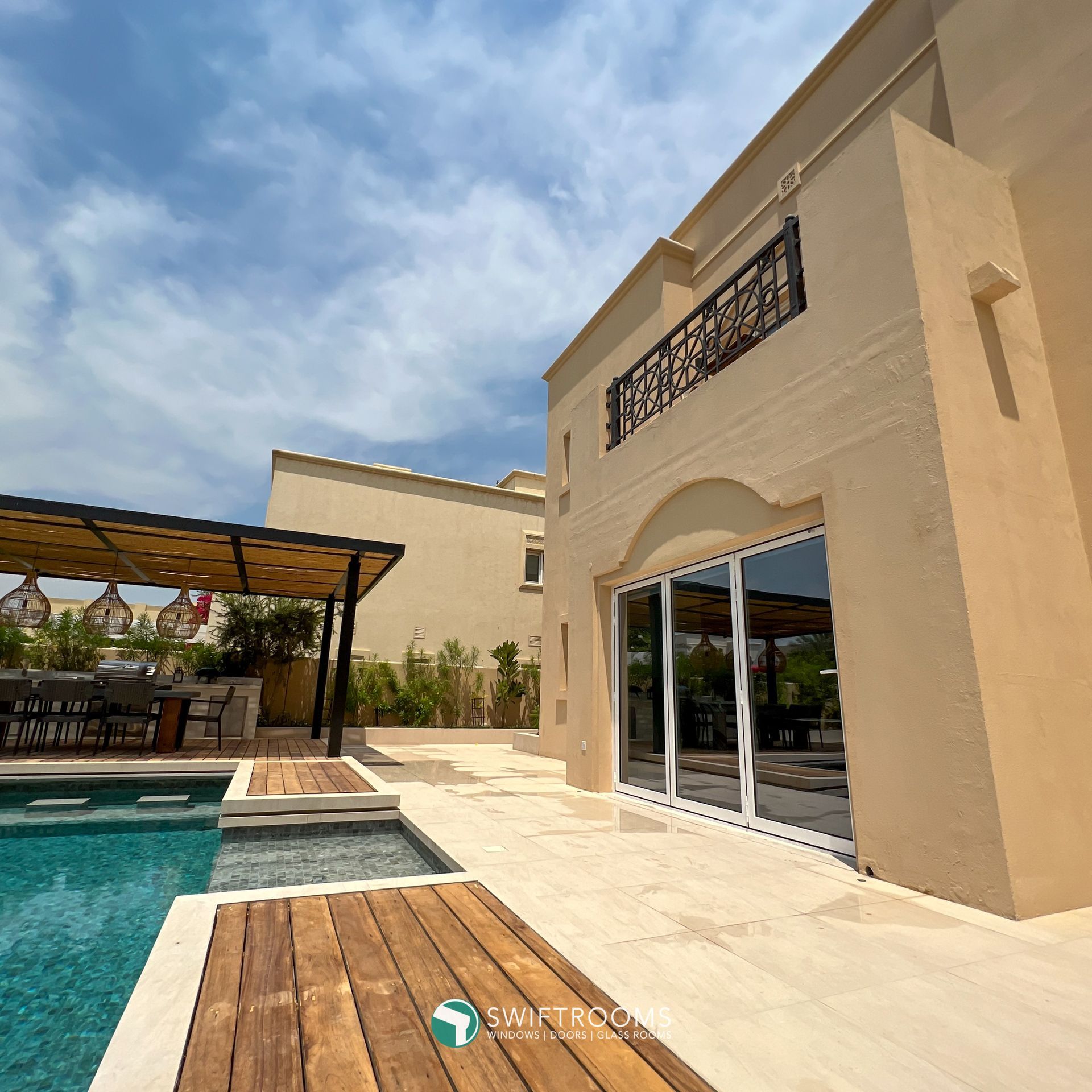 A large house with a swimming pool in front of it