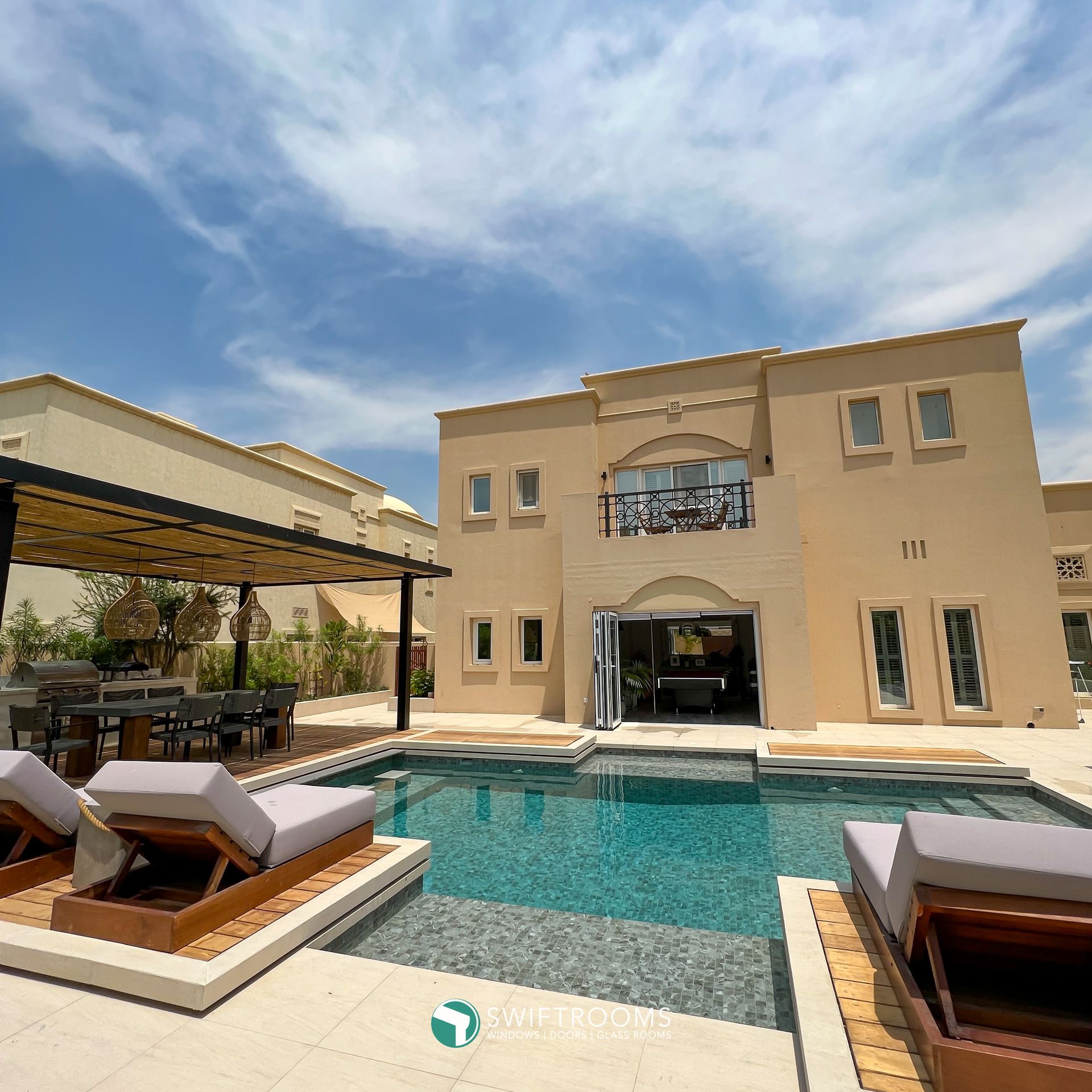 A large house with a large swimming pool in front of it