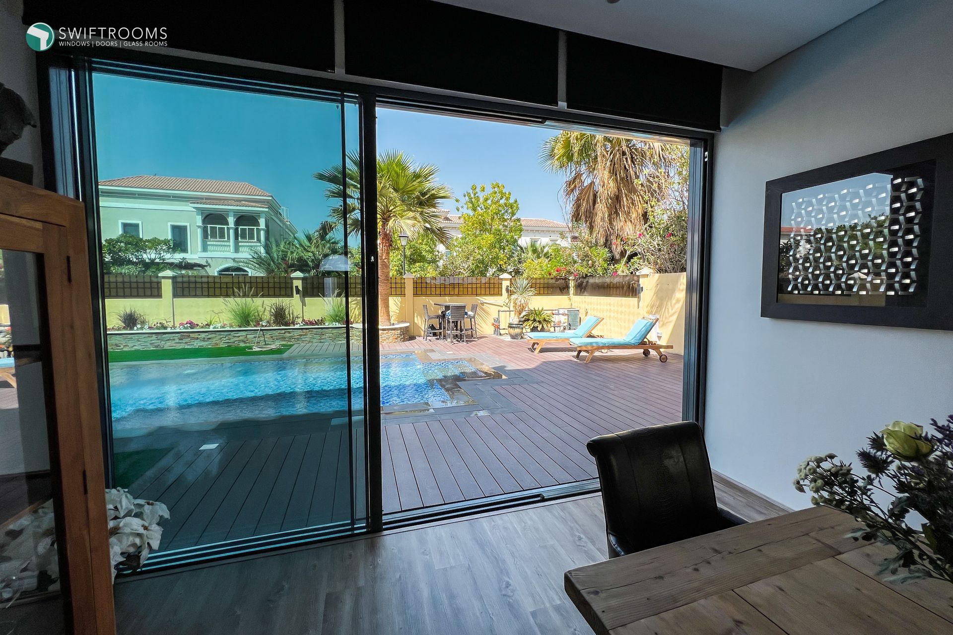 A room with a sliding glass door leading to a pool
