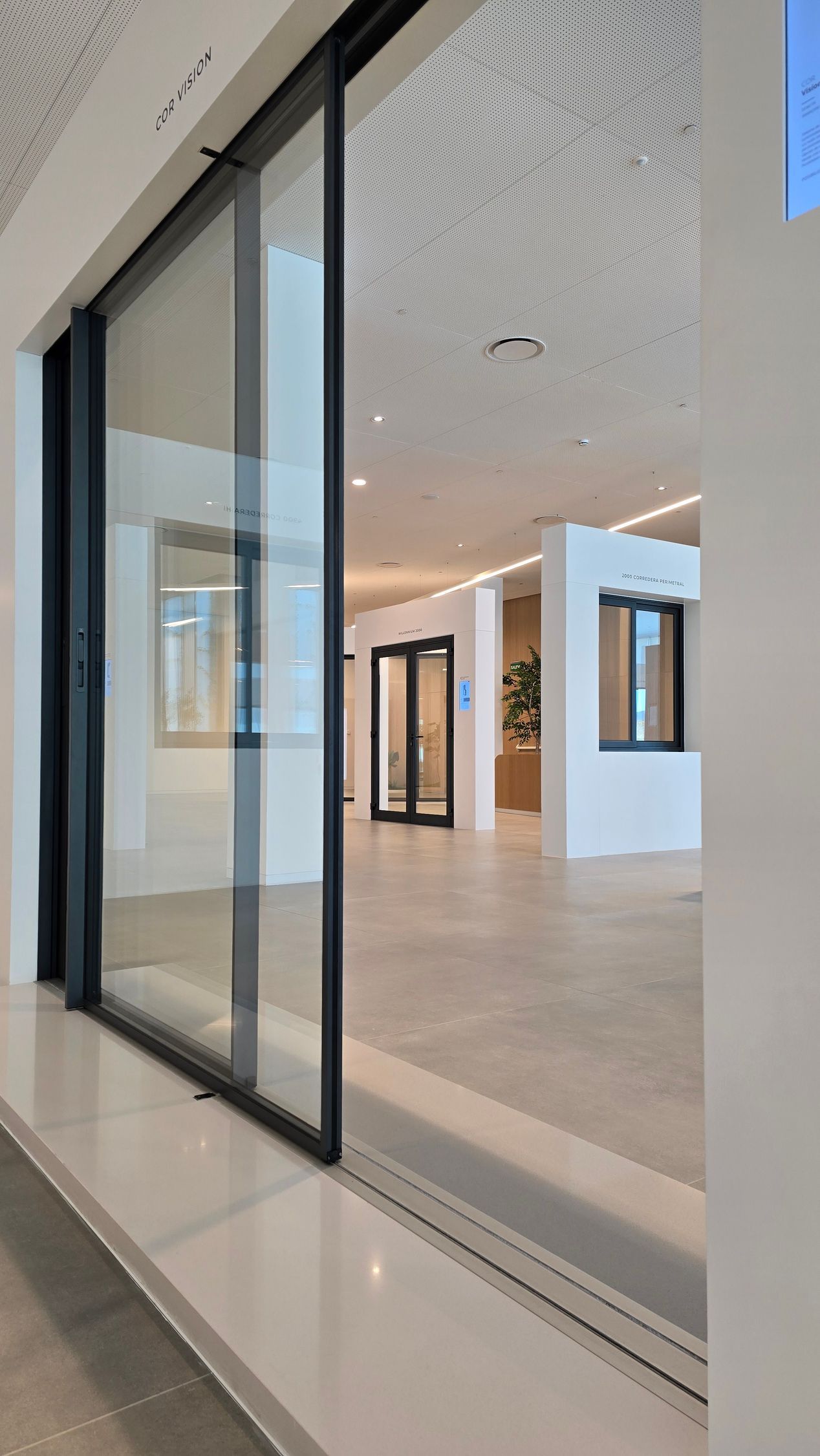 A room with a lot of windows and a sliding glass door.