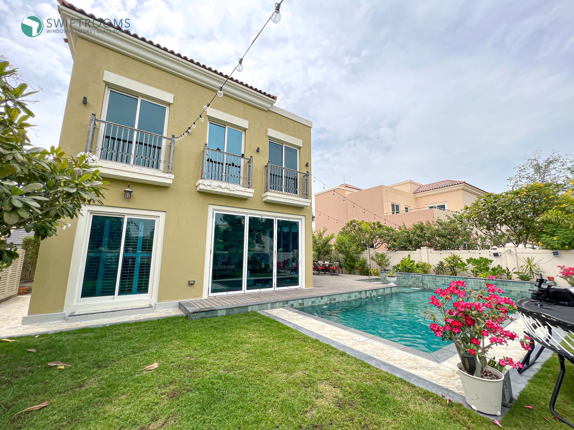 A large house with a swimming pool in the backyard.