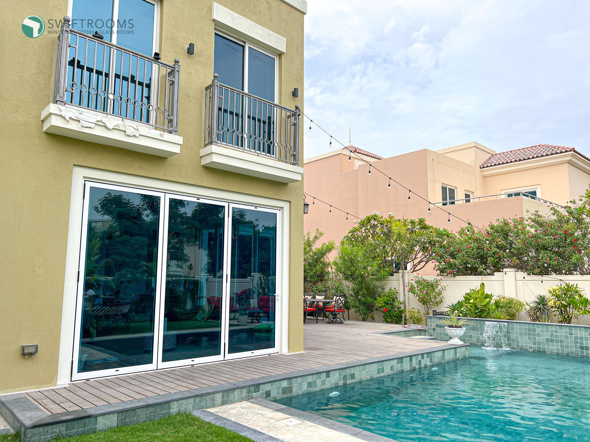 A large house with a swimming pool in front of it