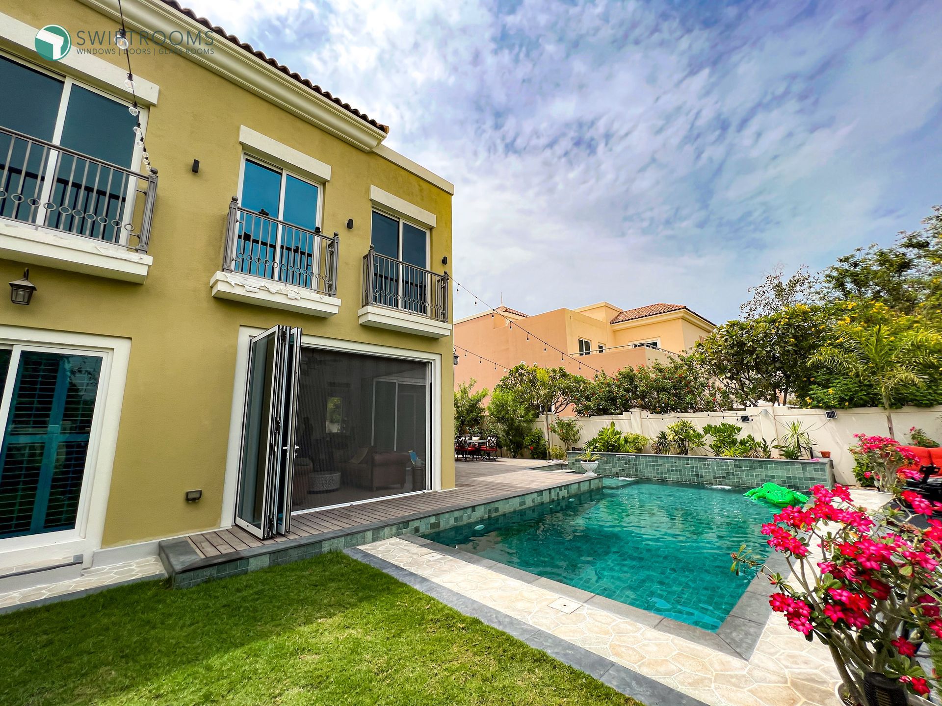 A large house with a swimming pool in the backyard.