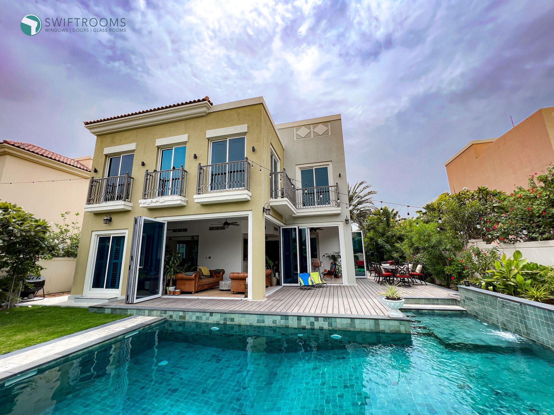 A large house with a swimming pool in front of it