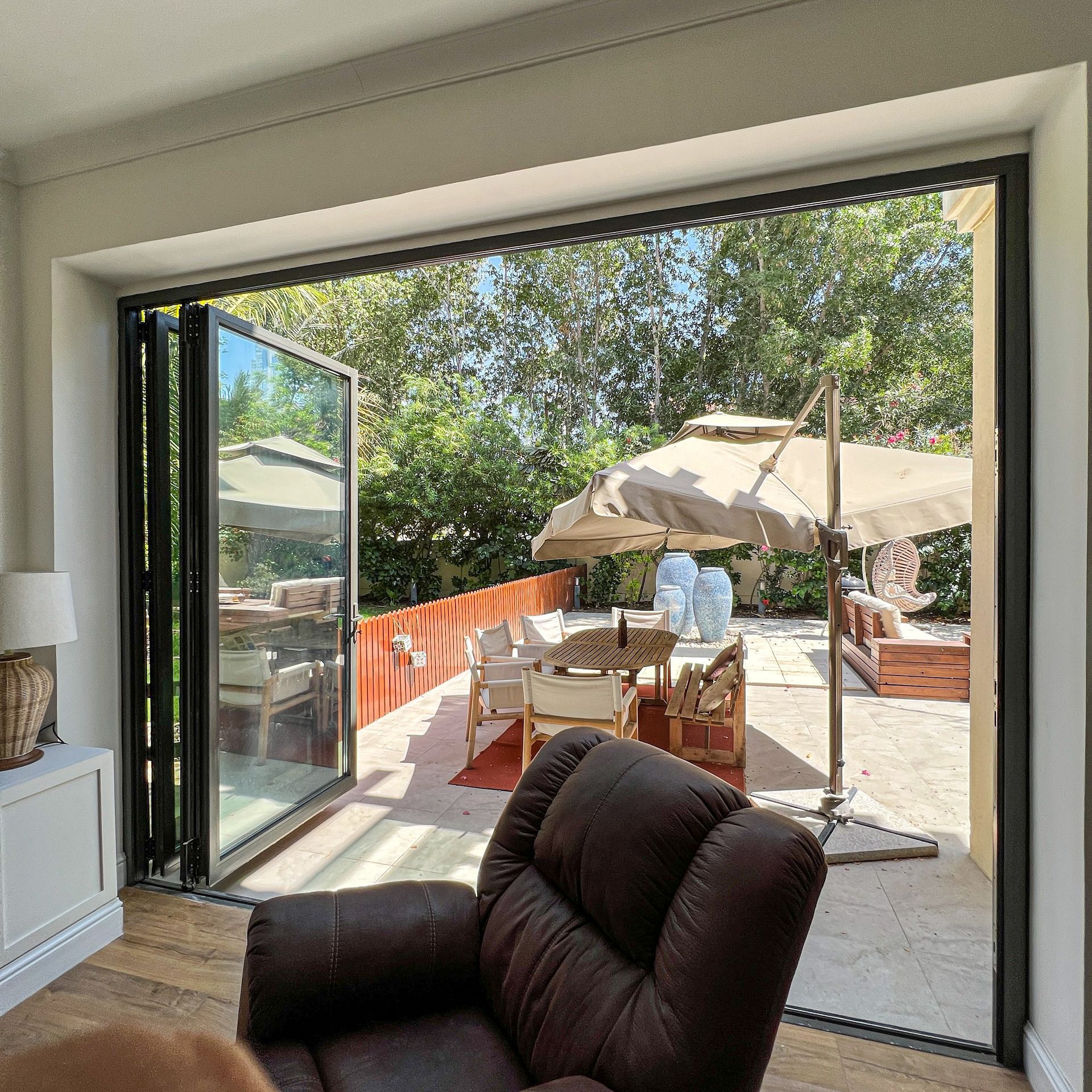 A living room with a large sliding glass door leading to a patio