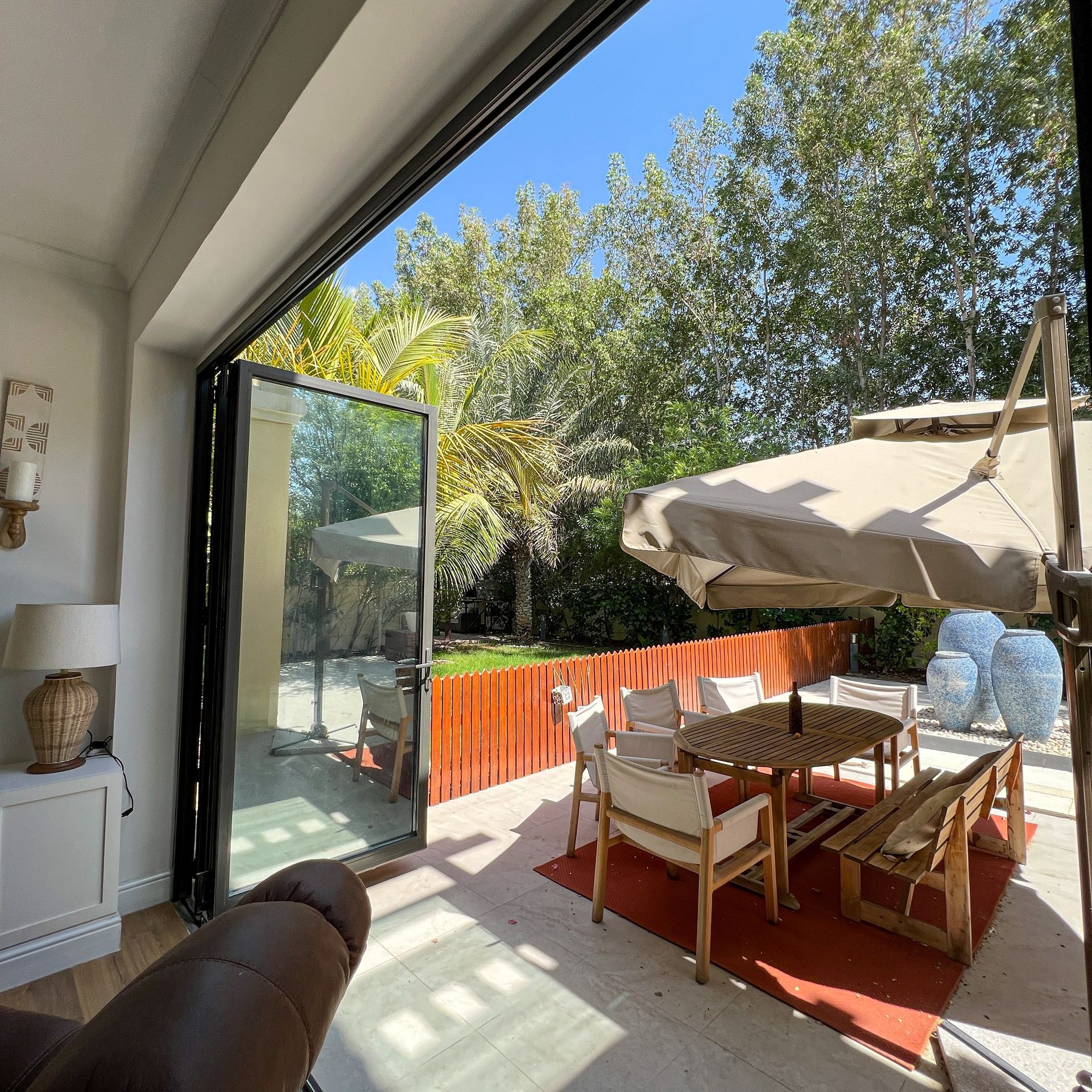 A patio with a table and chairs and an umbrella