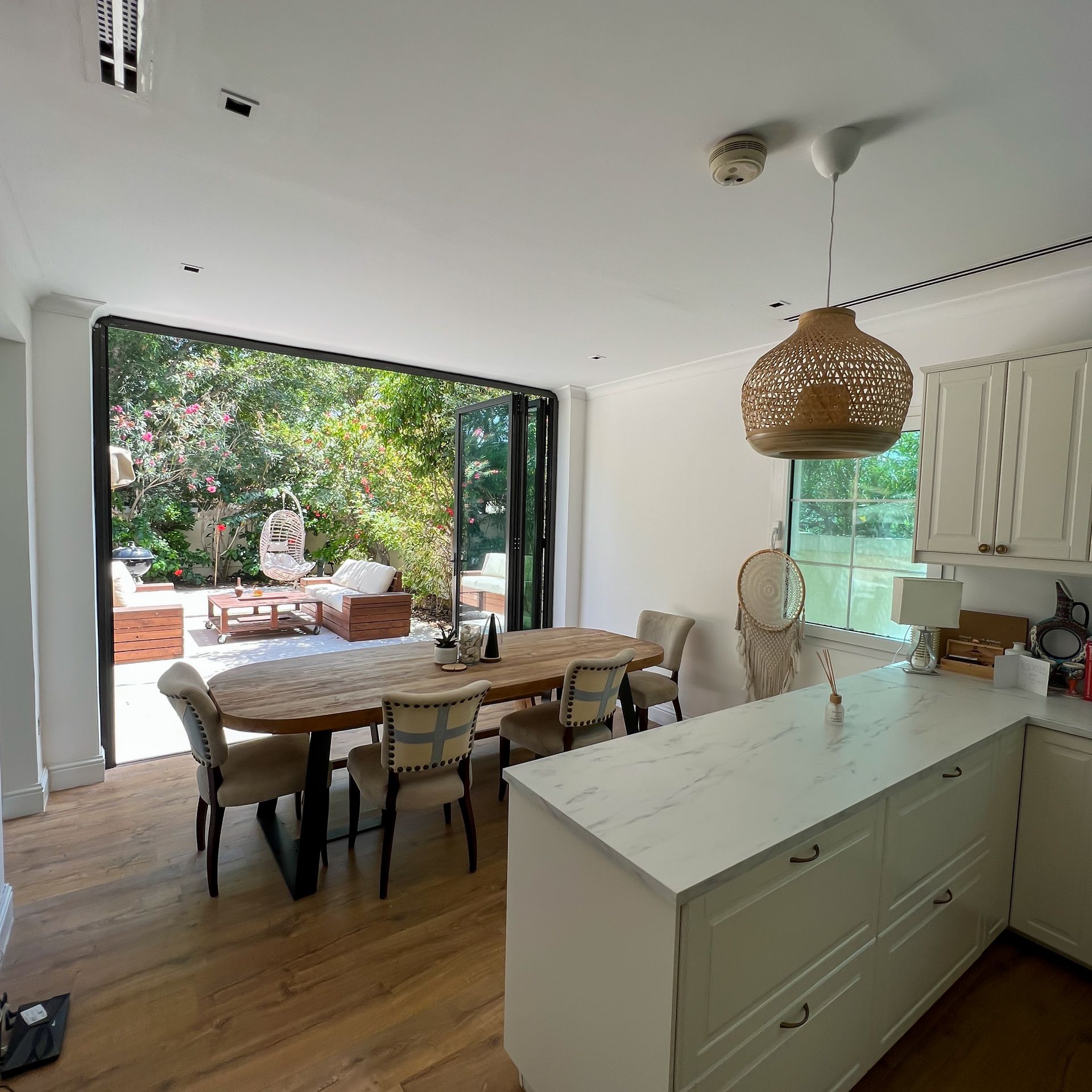 A kitchen with a table and chairs in it
