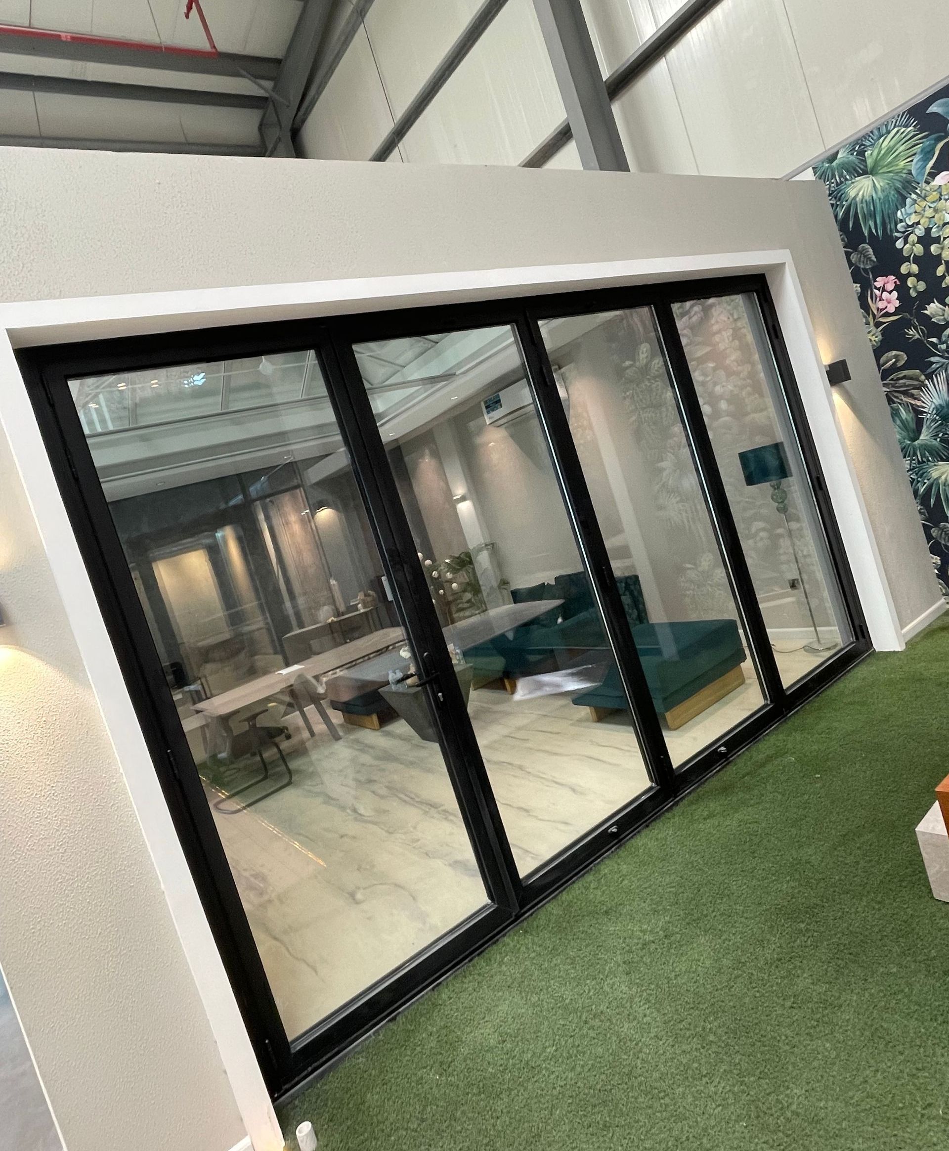 A room with a lot of windows and a couch in it