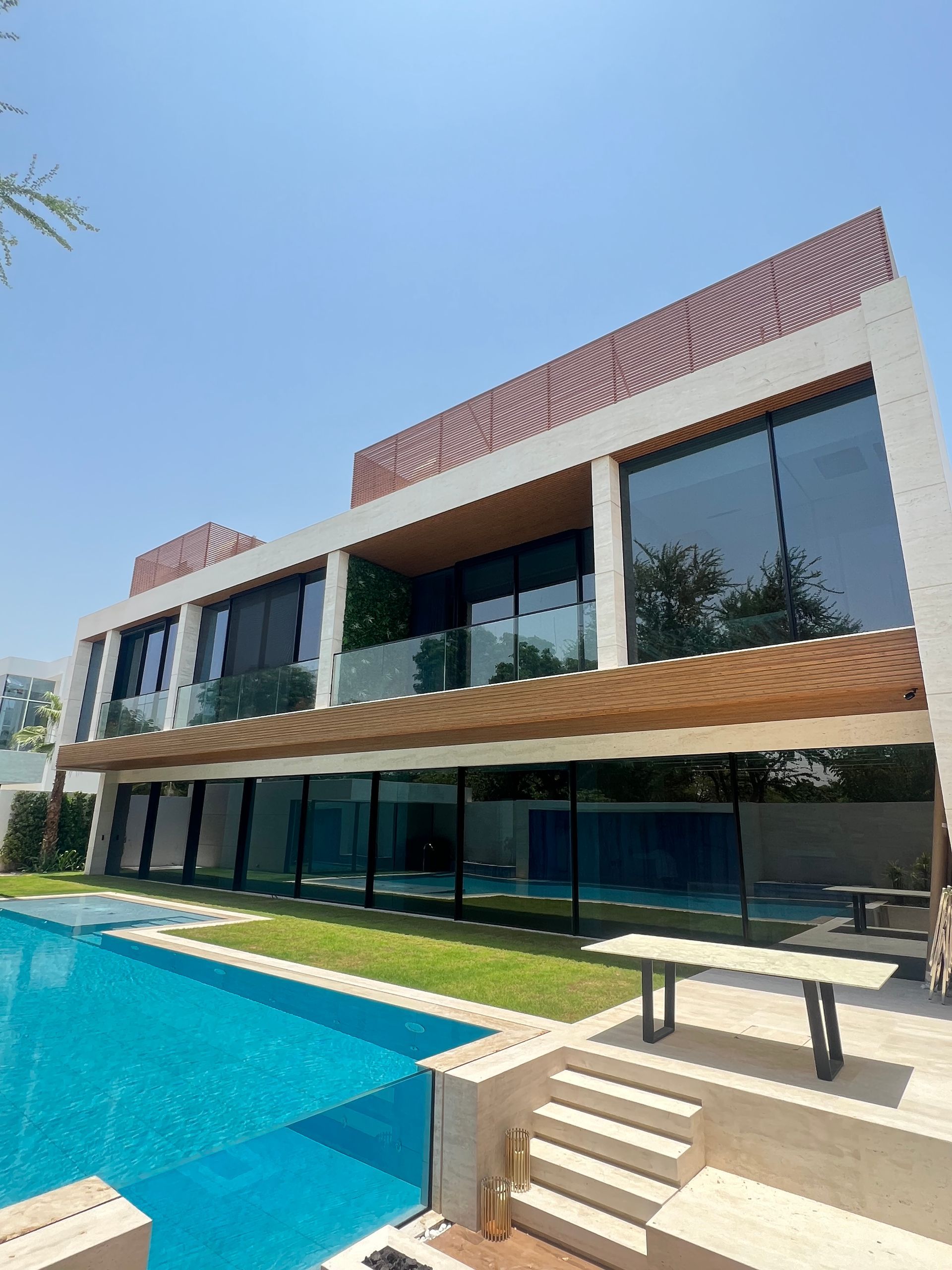 A large house with a swimming pool in front of it.
