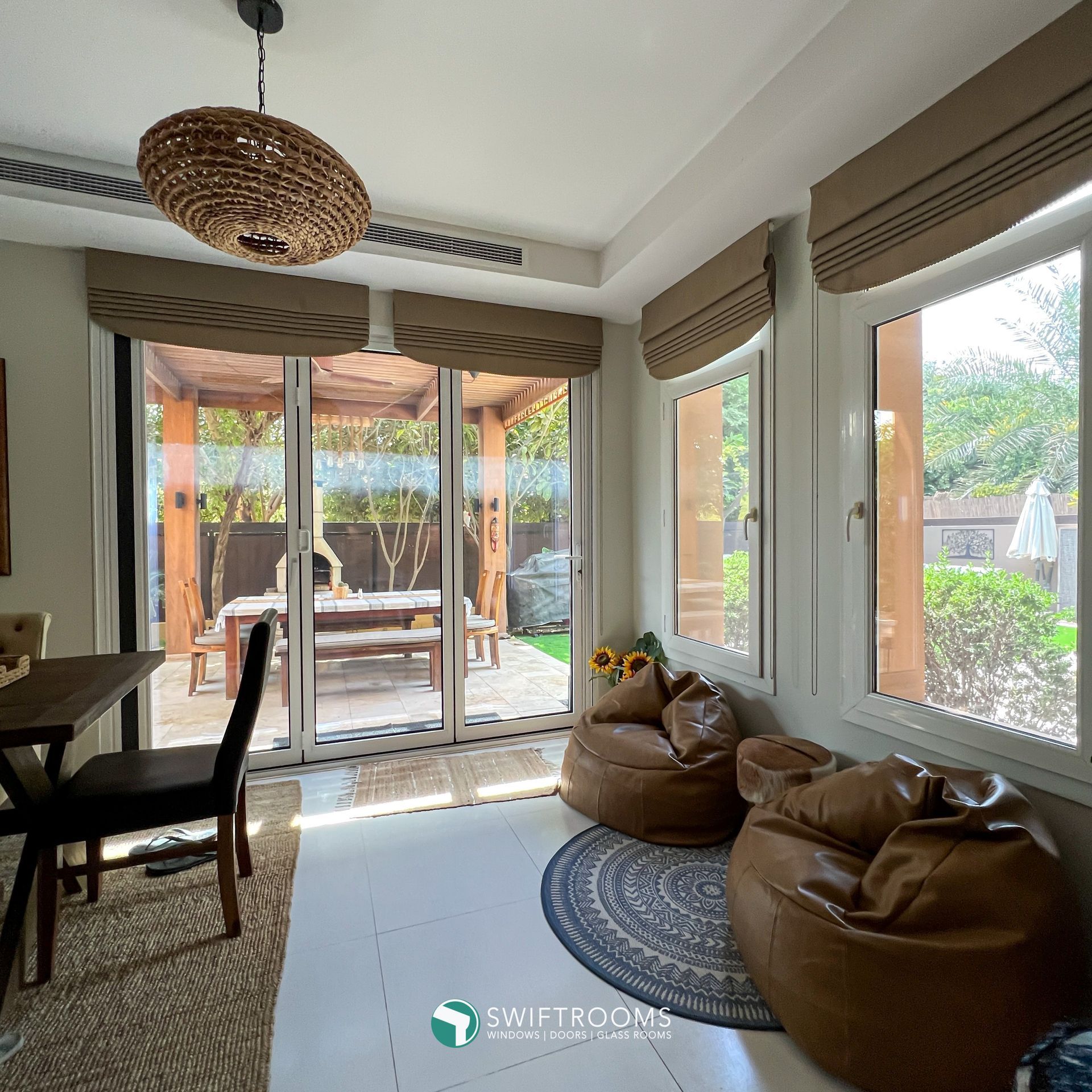 A living room with lots of windows and bean bag chairs