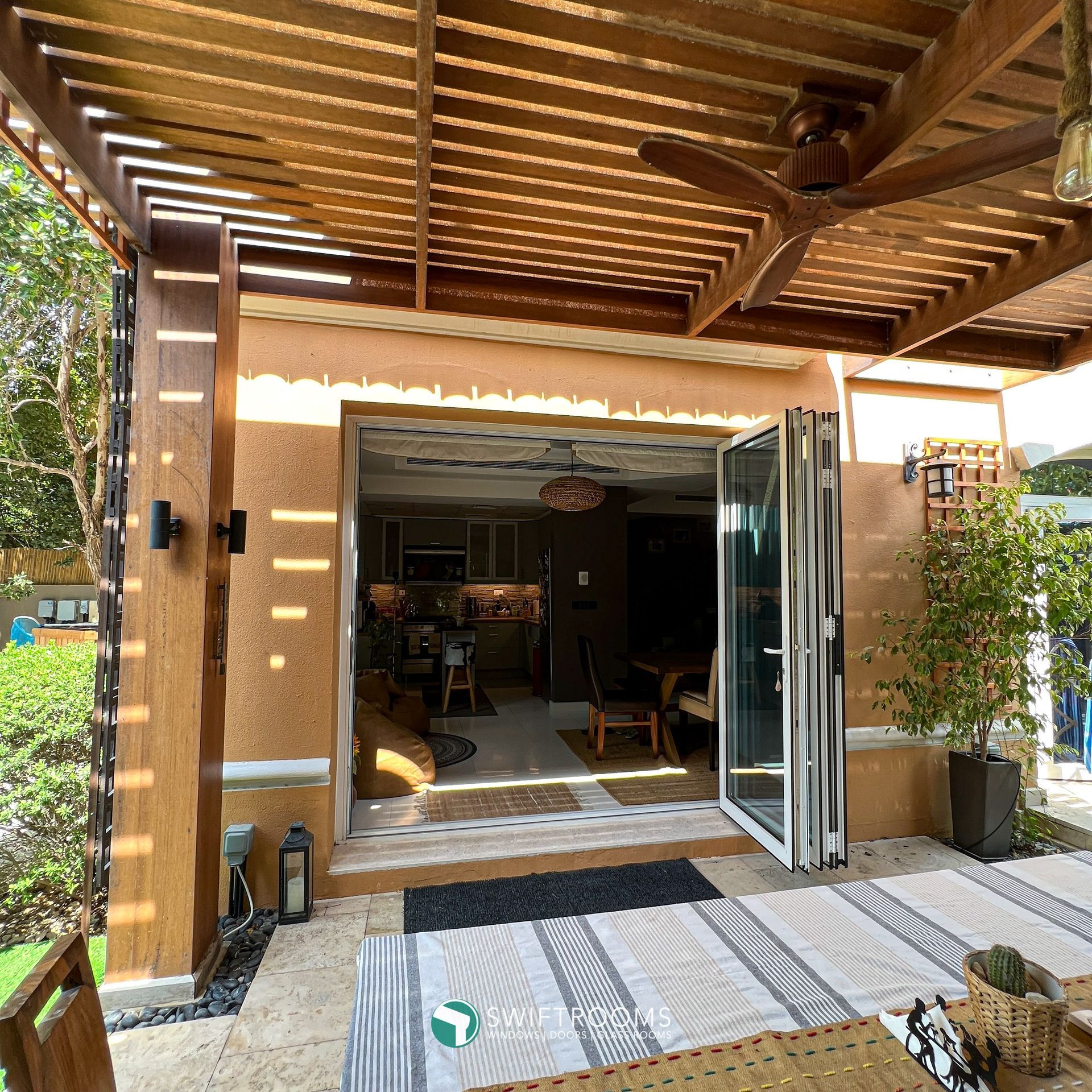 A house with a wooden pergola and sliding glass doors