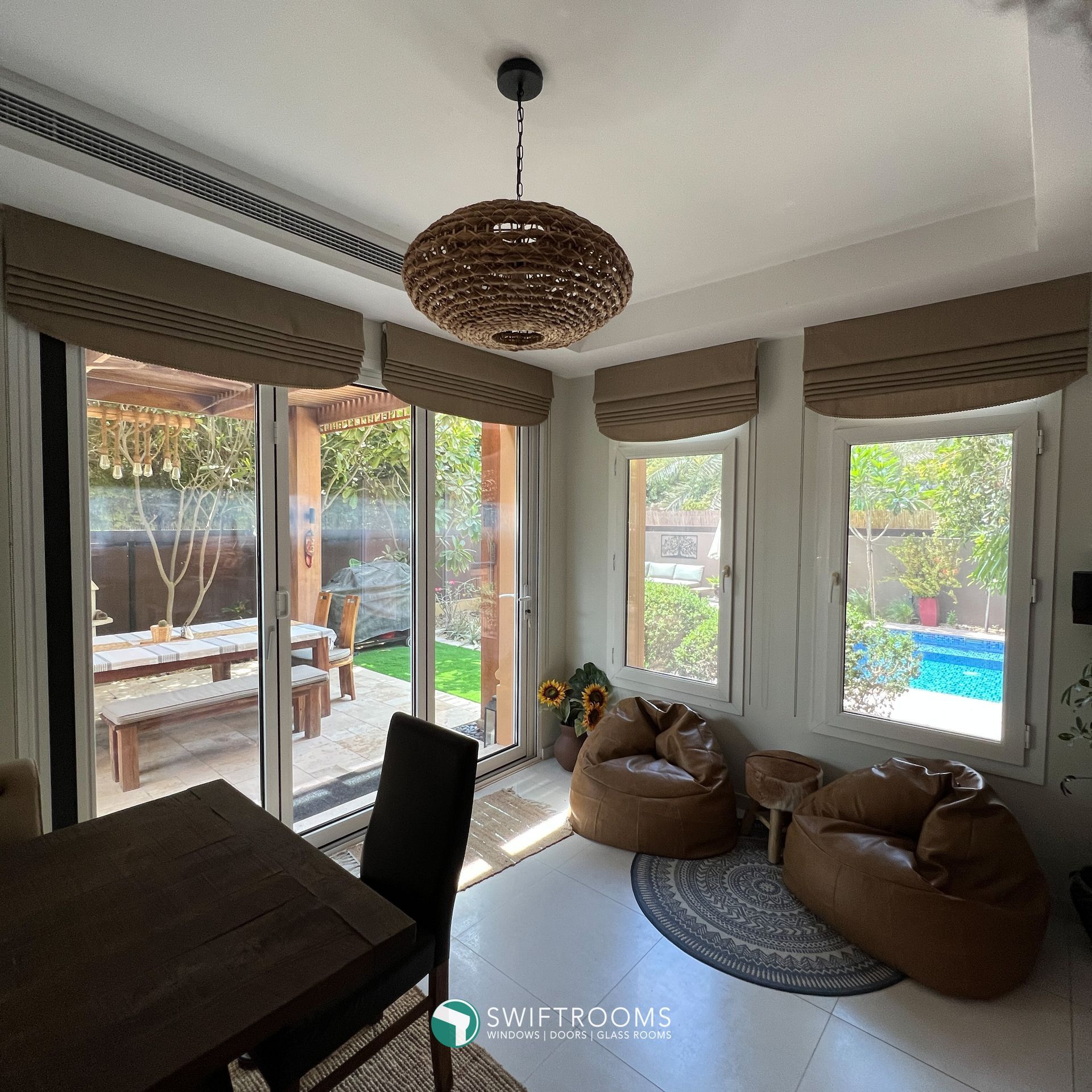 A living room with a table and chairs and a sliding glass door