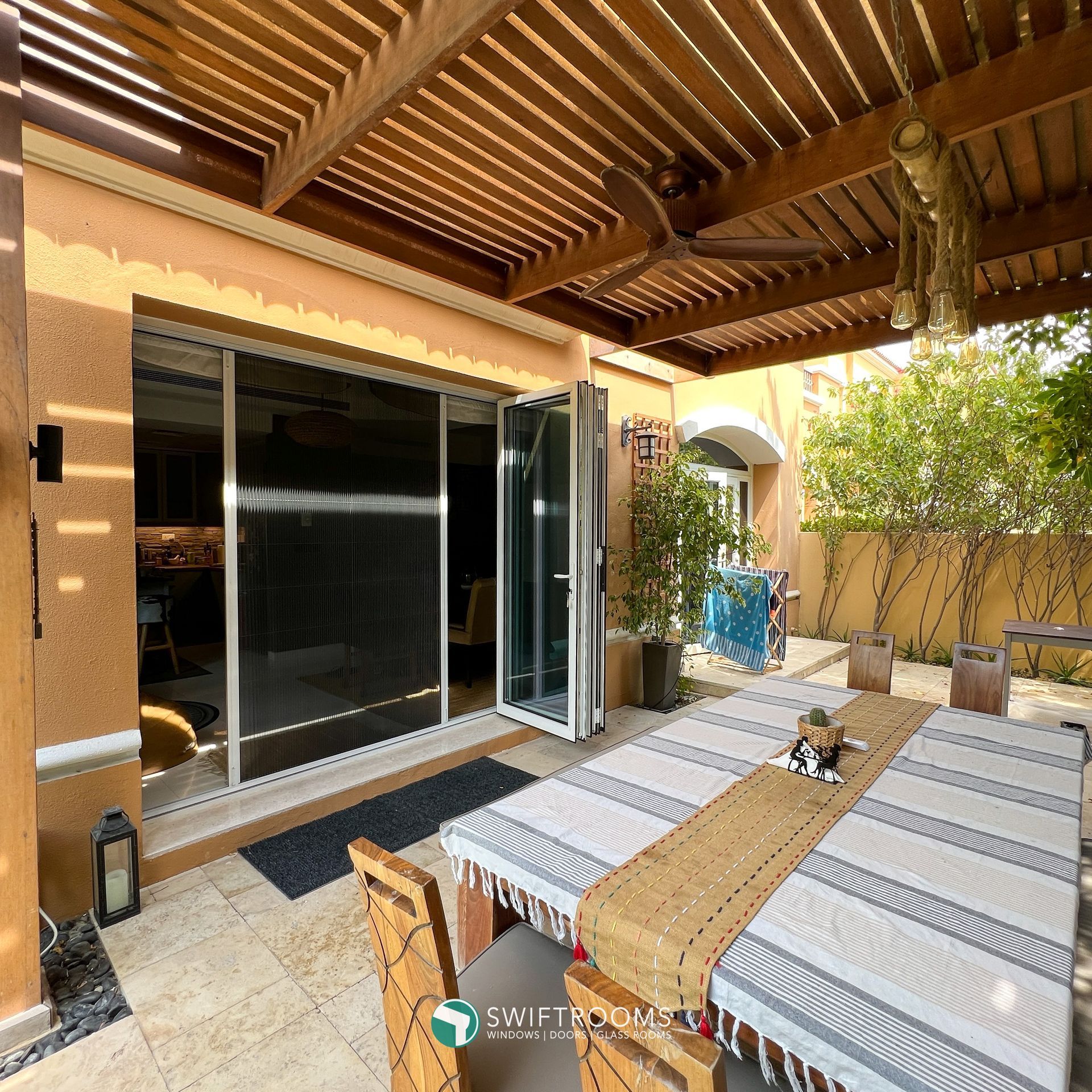 A patio with a table and chairs under a pergola