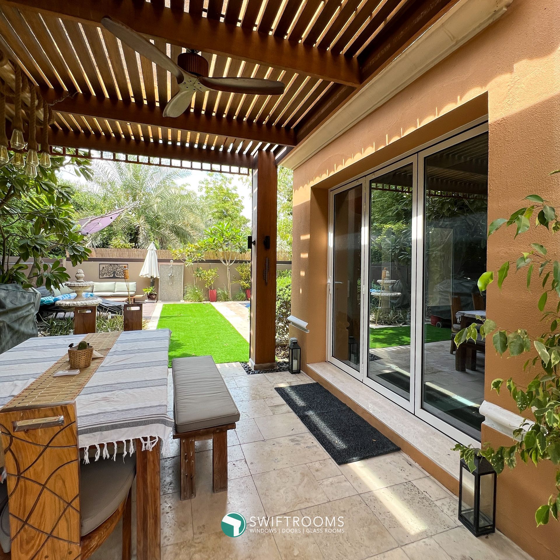 A patio with a table and chairs under a pergola
