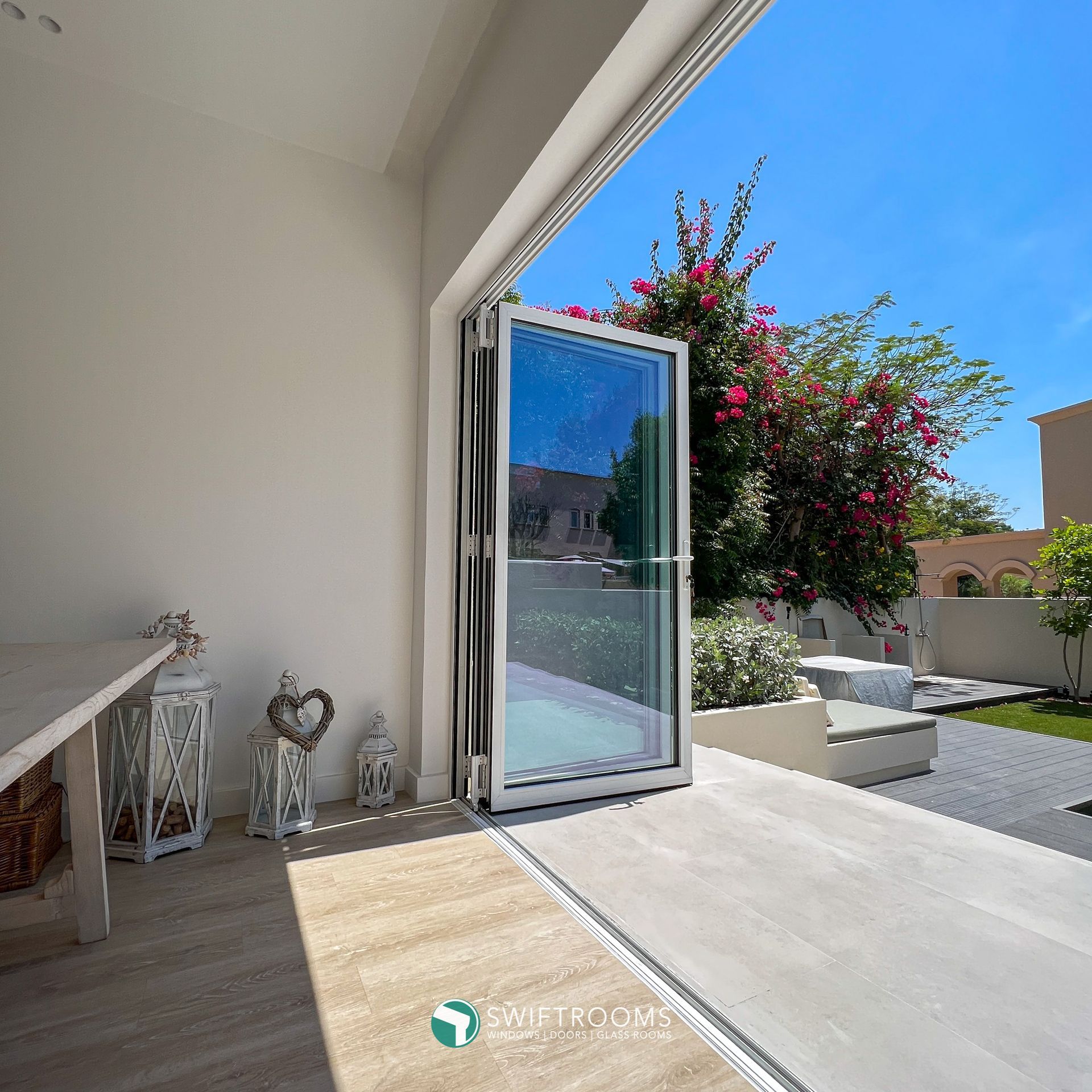 A room with a sliding glass door leading to a garden