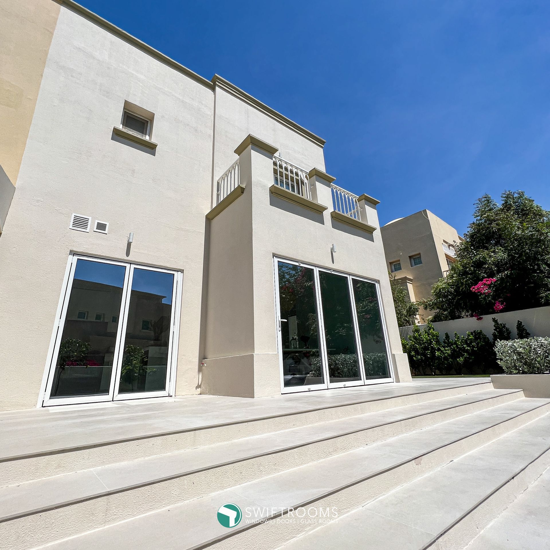 A white building with a lot of windows and stairs
