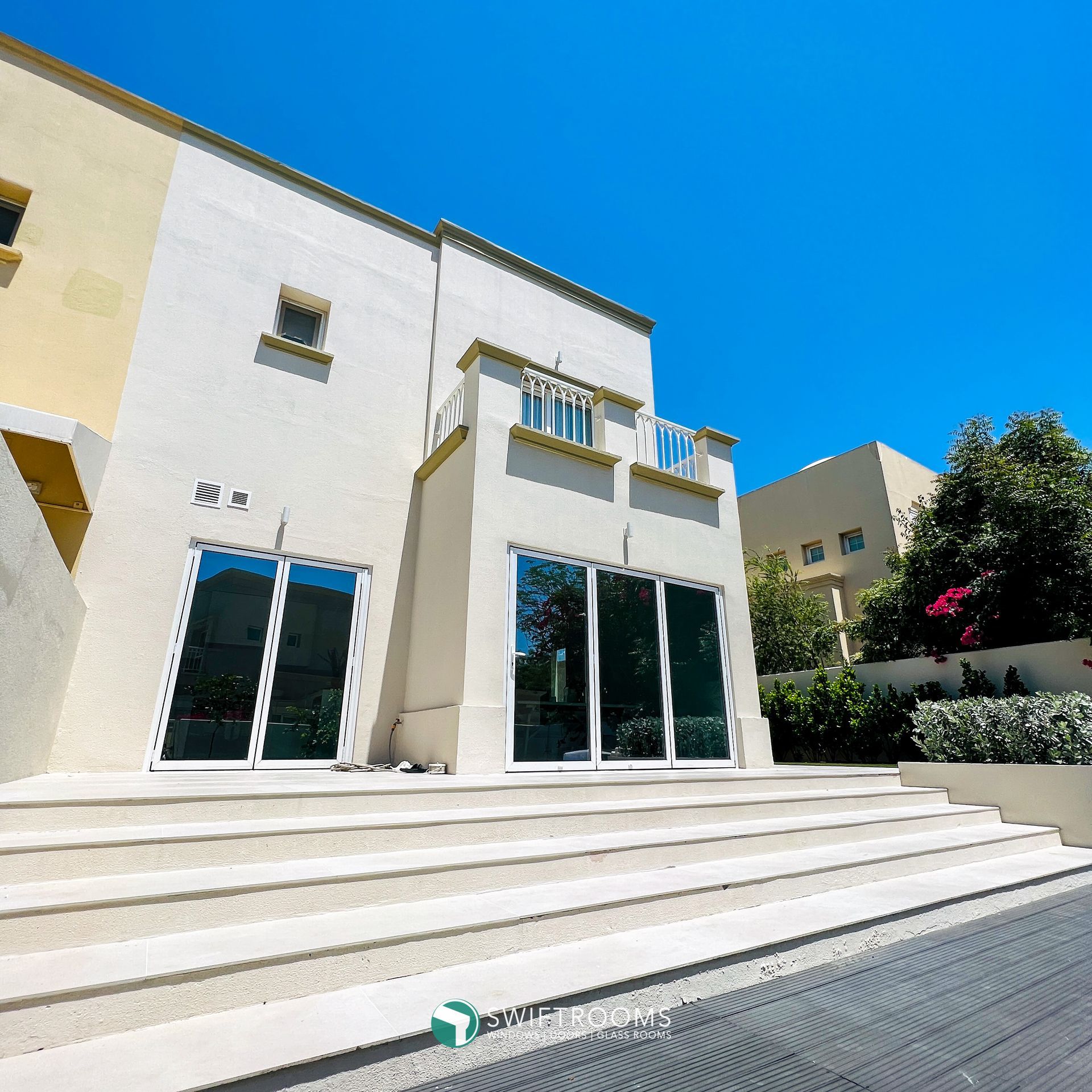 A large white building with stairs leading up to it