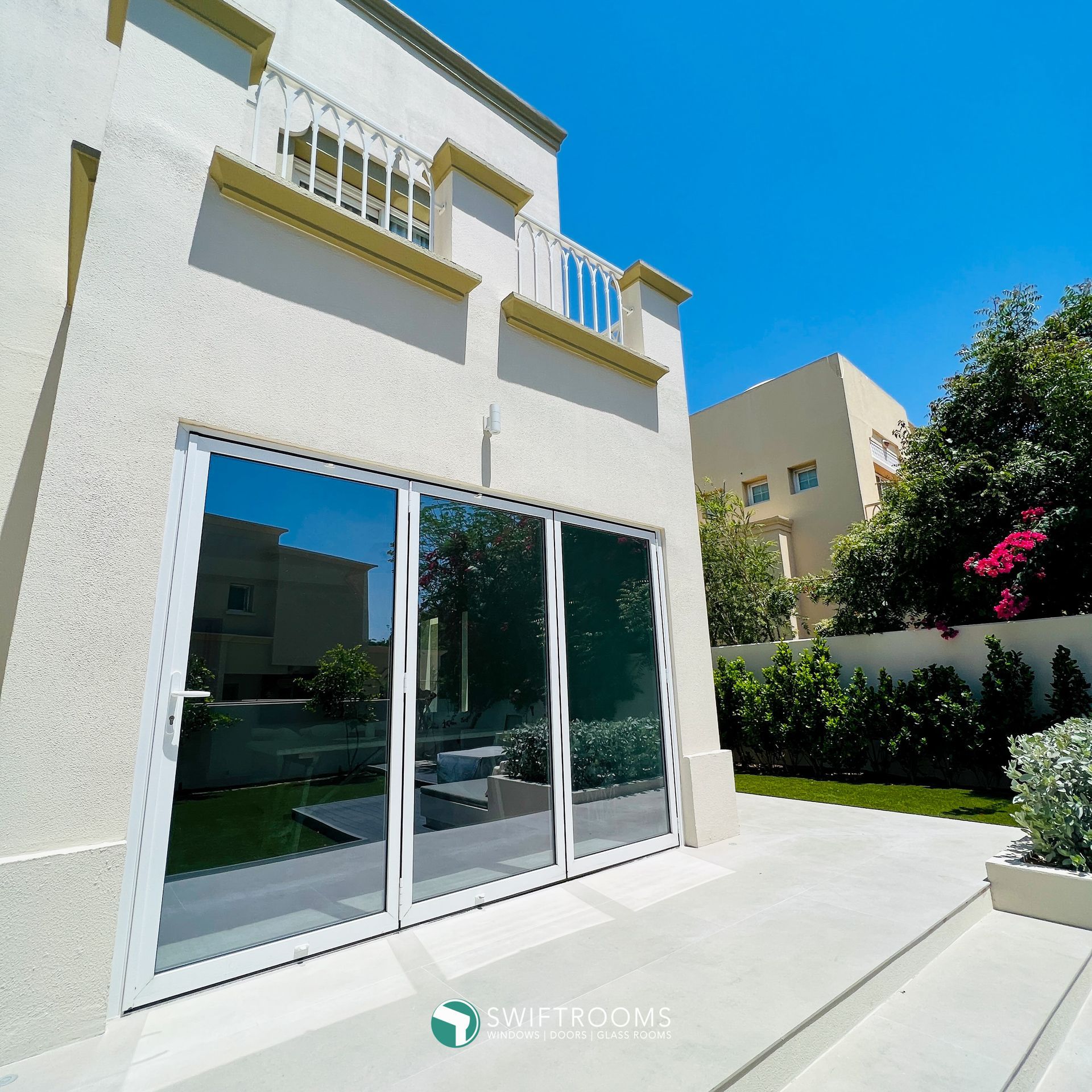 A white house with a large sliding glass door
