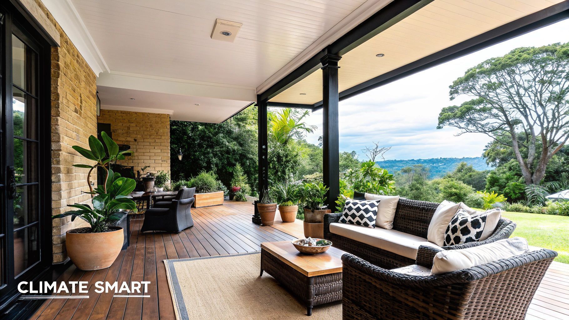 Covered outdoor patio with seating, plants, and scenic view.