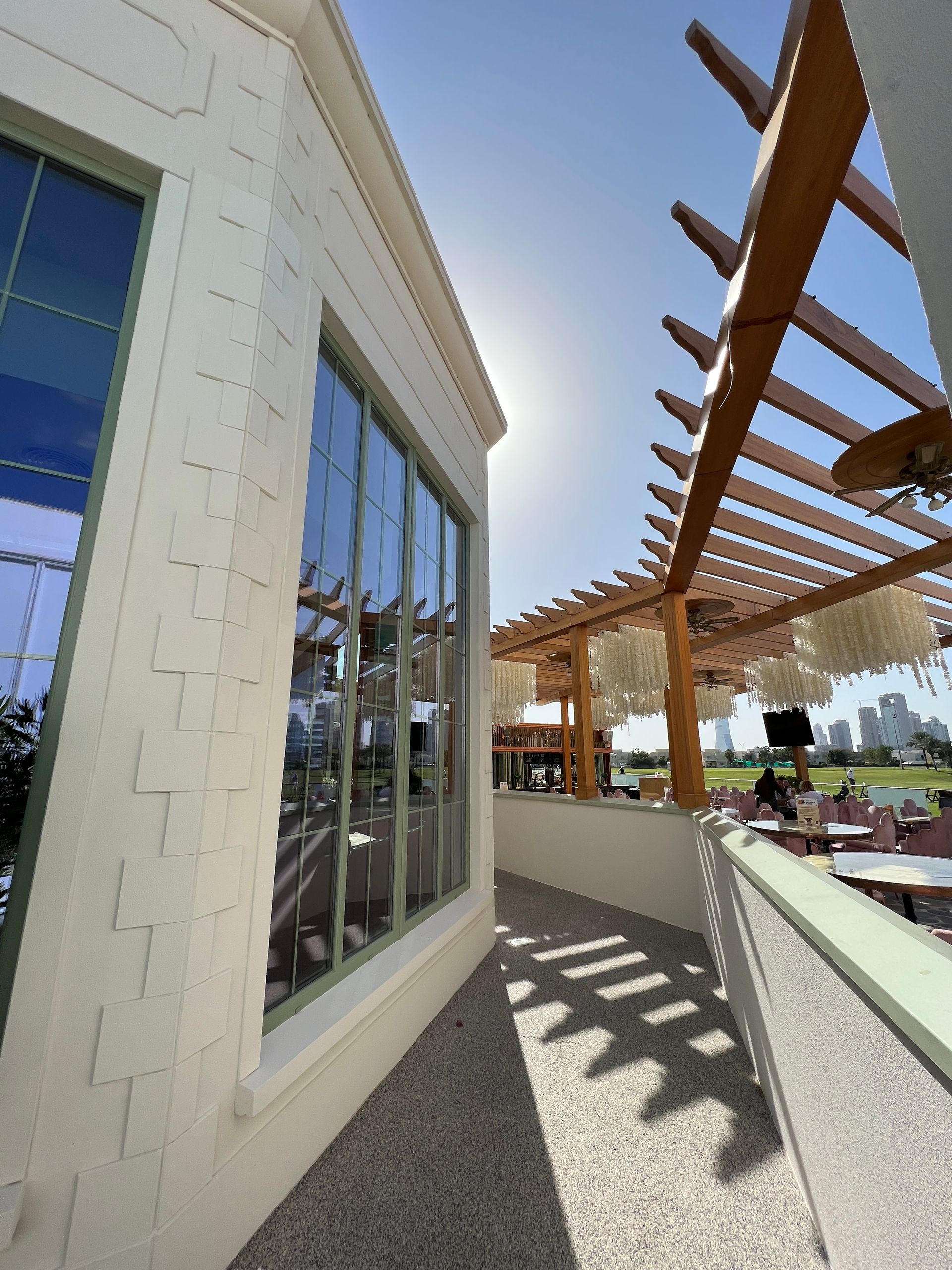 A building with a pergola and a large window