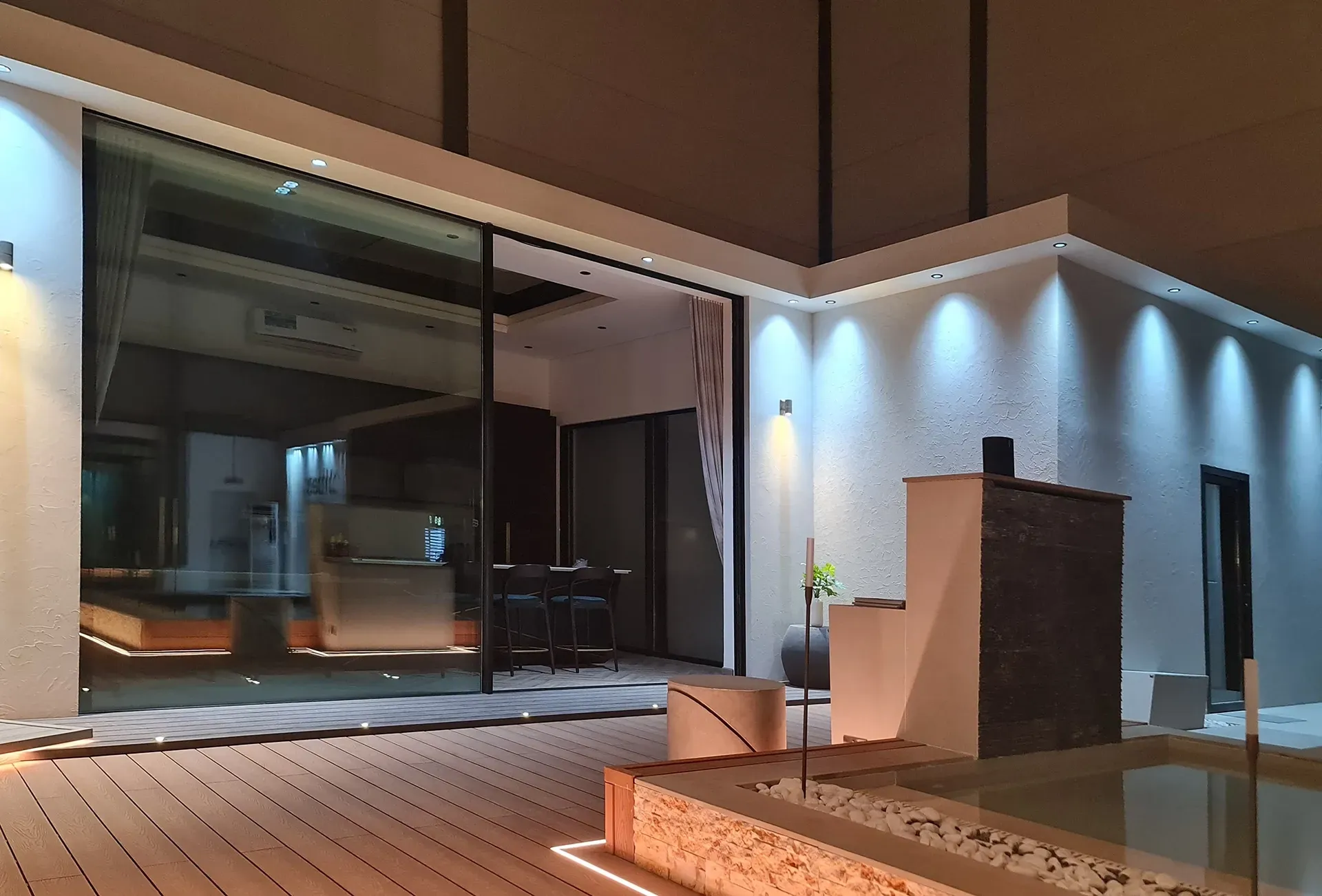 A large building with a sliding glass door is lit up at night