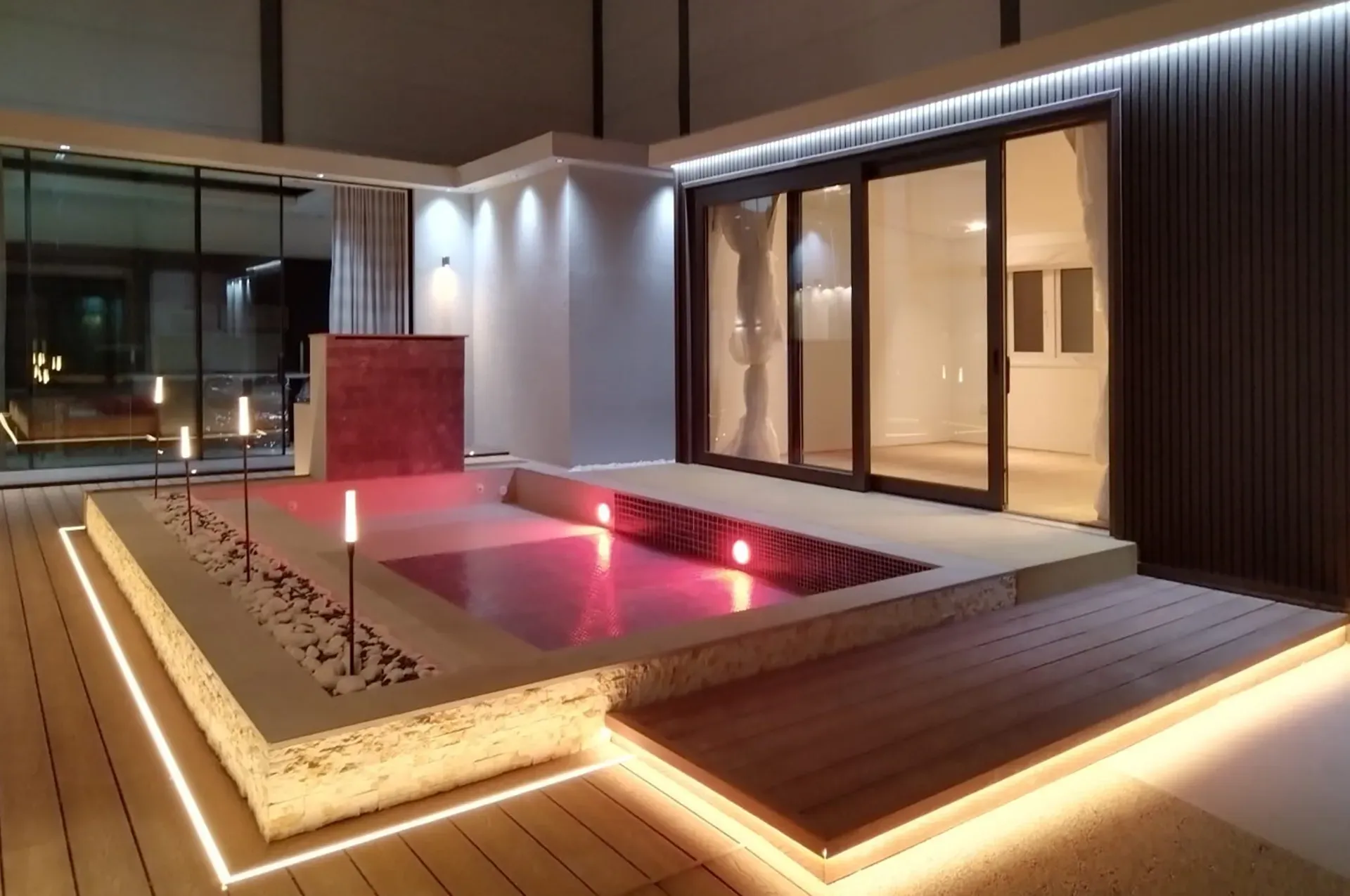 A large room with a swimming pool in the middle of it.