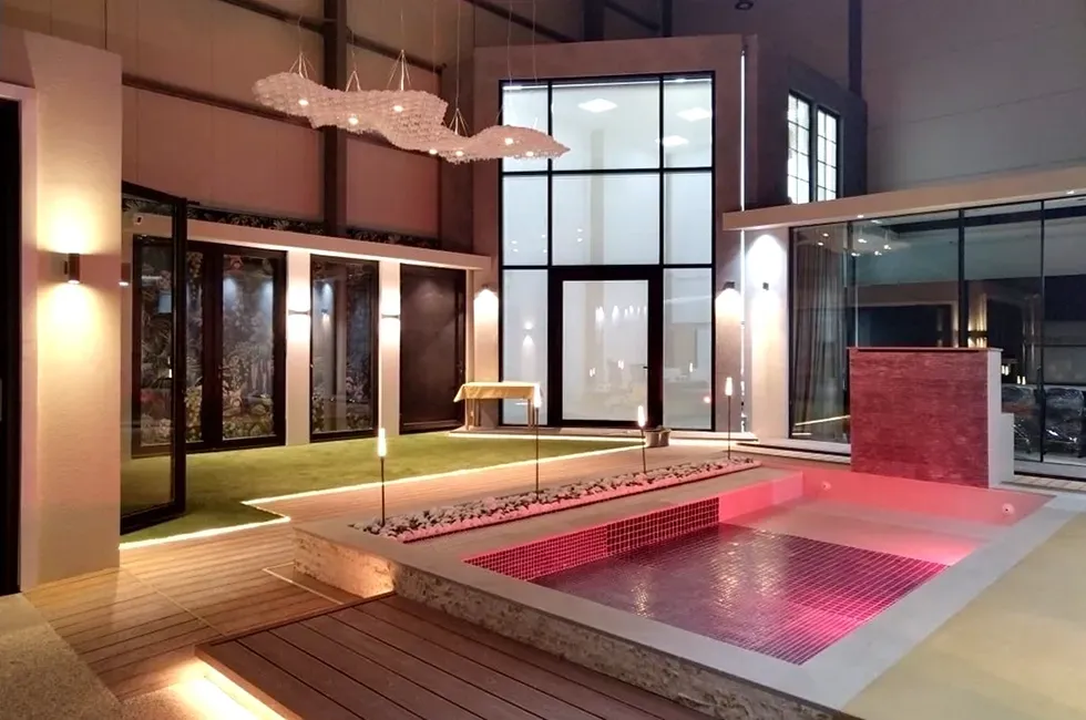 A large room with a swimming pool in the middle of it