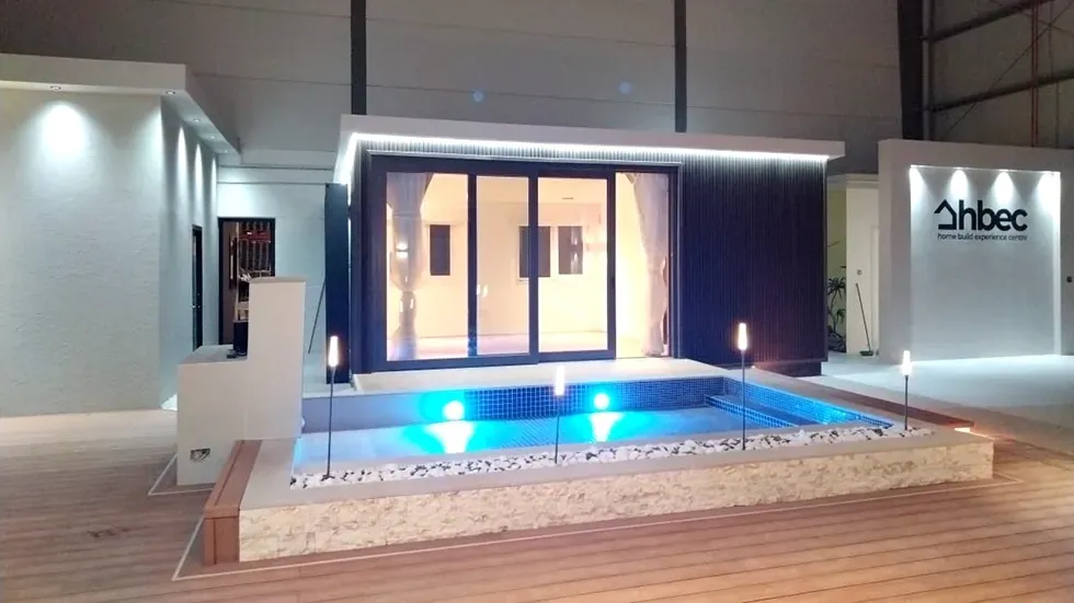 A building with a swimming pool in front of it