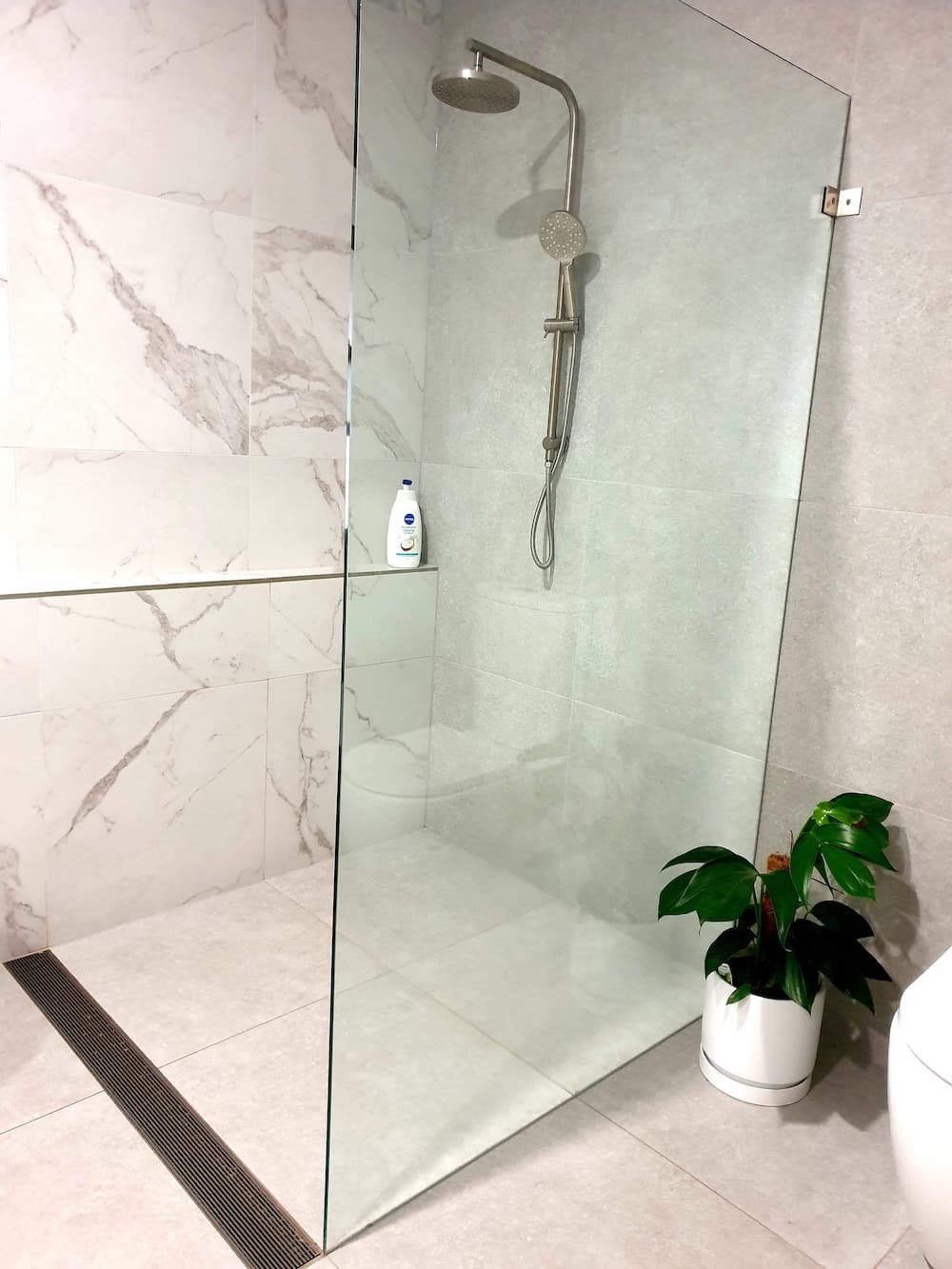 Glass Shower With Marble Tiles  — Home Renovations in Port Macquarie, NSW