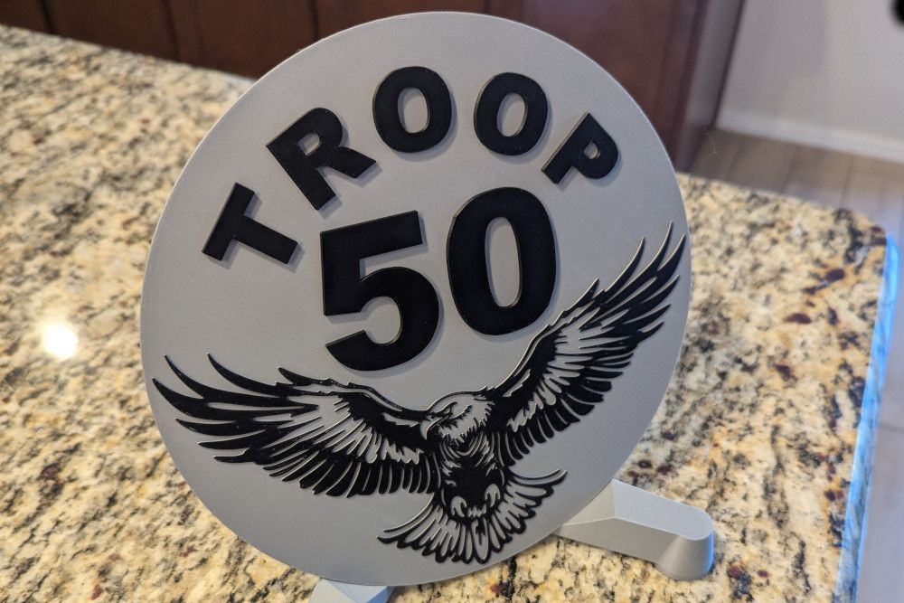 A sign that says troop 50 with an eagle on it