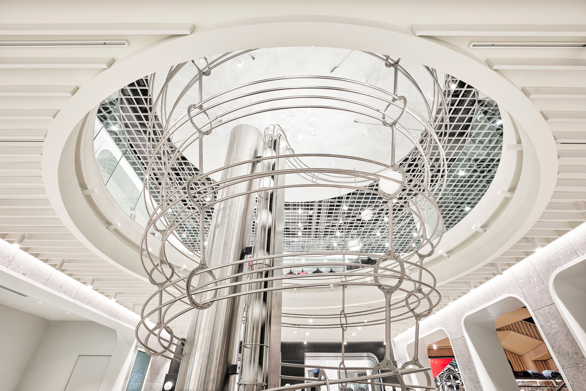 A large metal structure is hanging from the ceiling of a building.