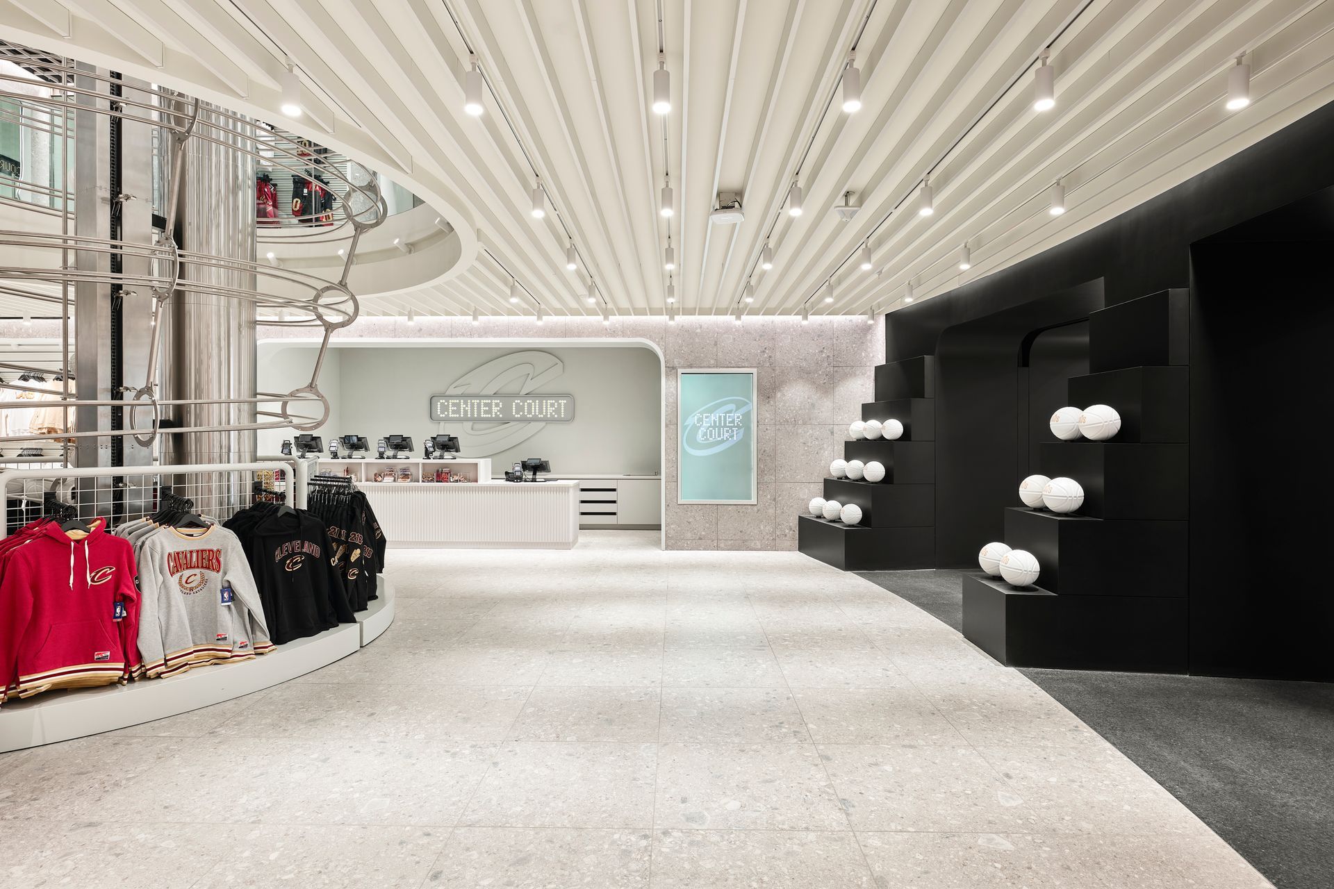 A store with a lot of clothes on display and a ceiling that looks like a ceiling fan.