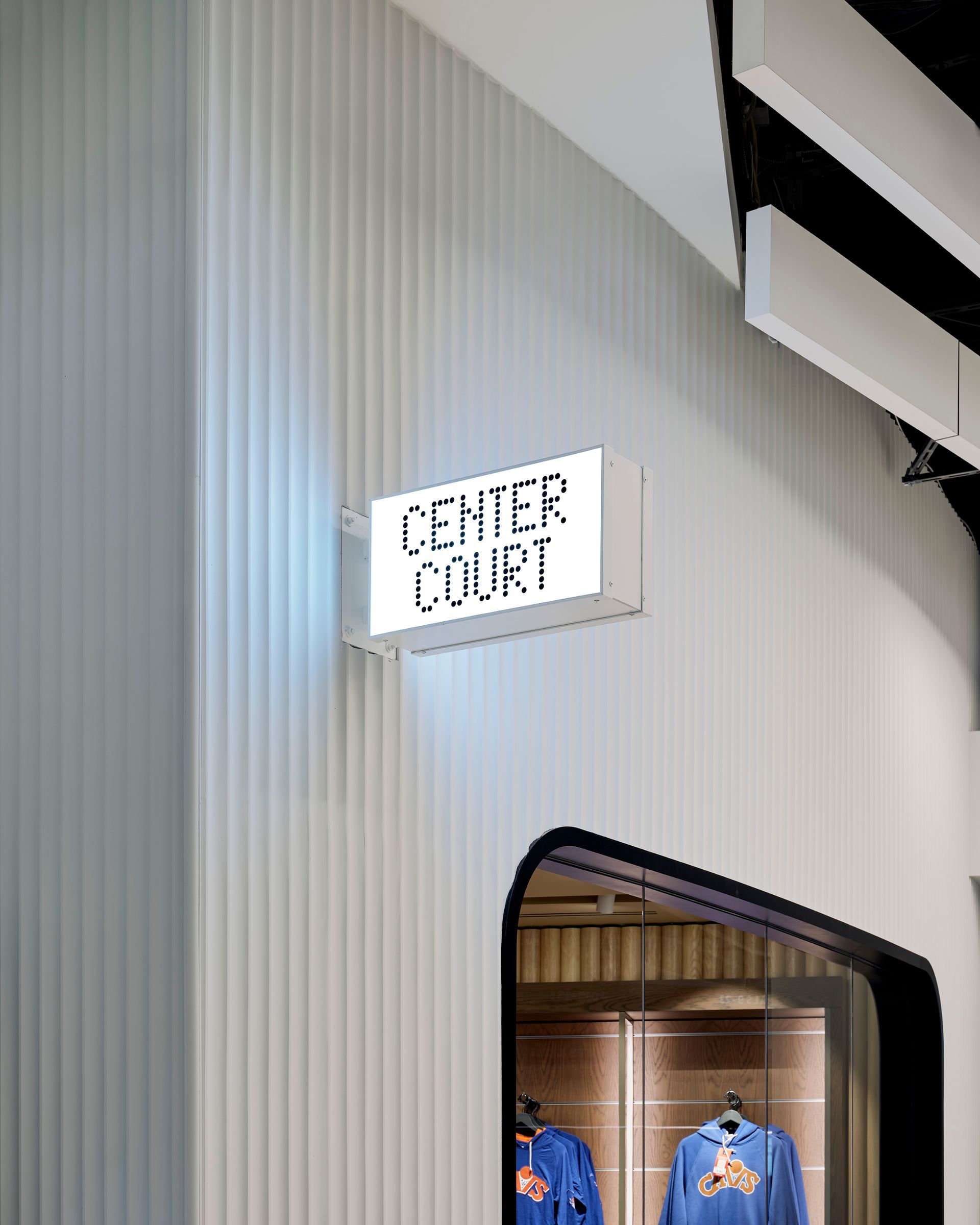 A store front with a sign on the wall that says center court.