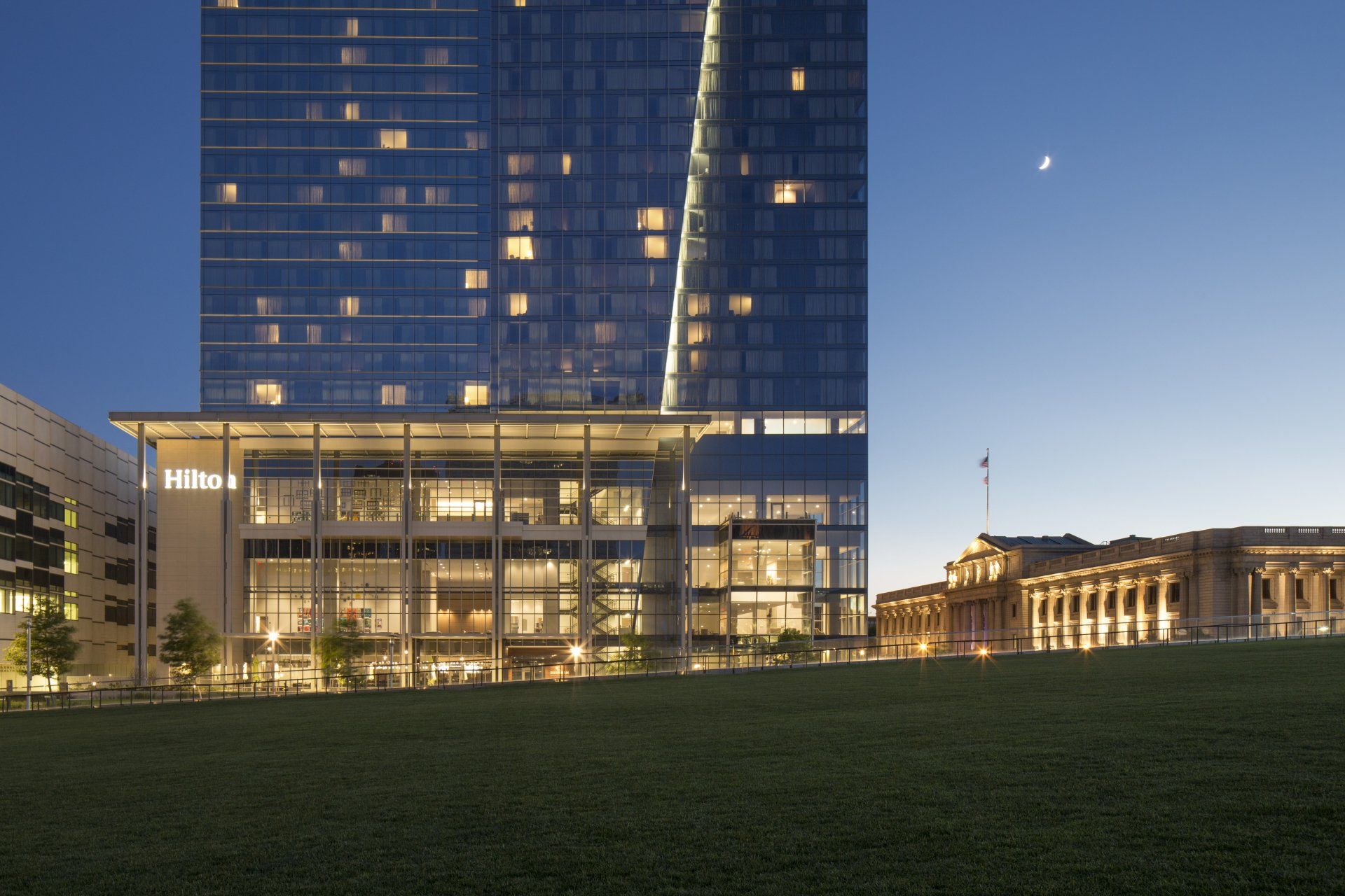 A large building with a lot of windows is lit up at night
