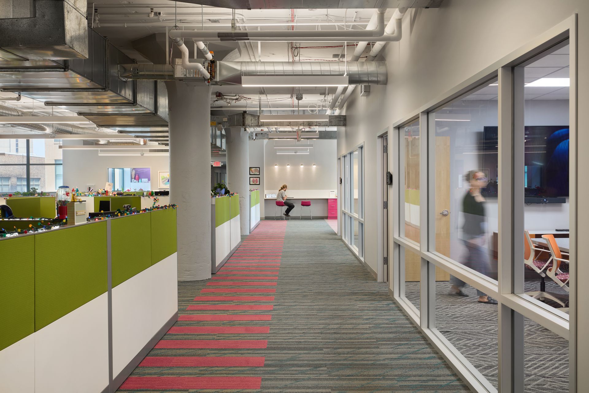 An office with cubicles and a sign that says fit technologies