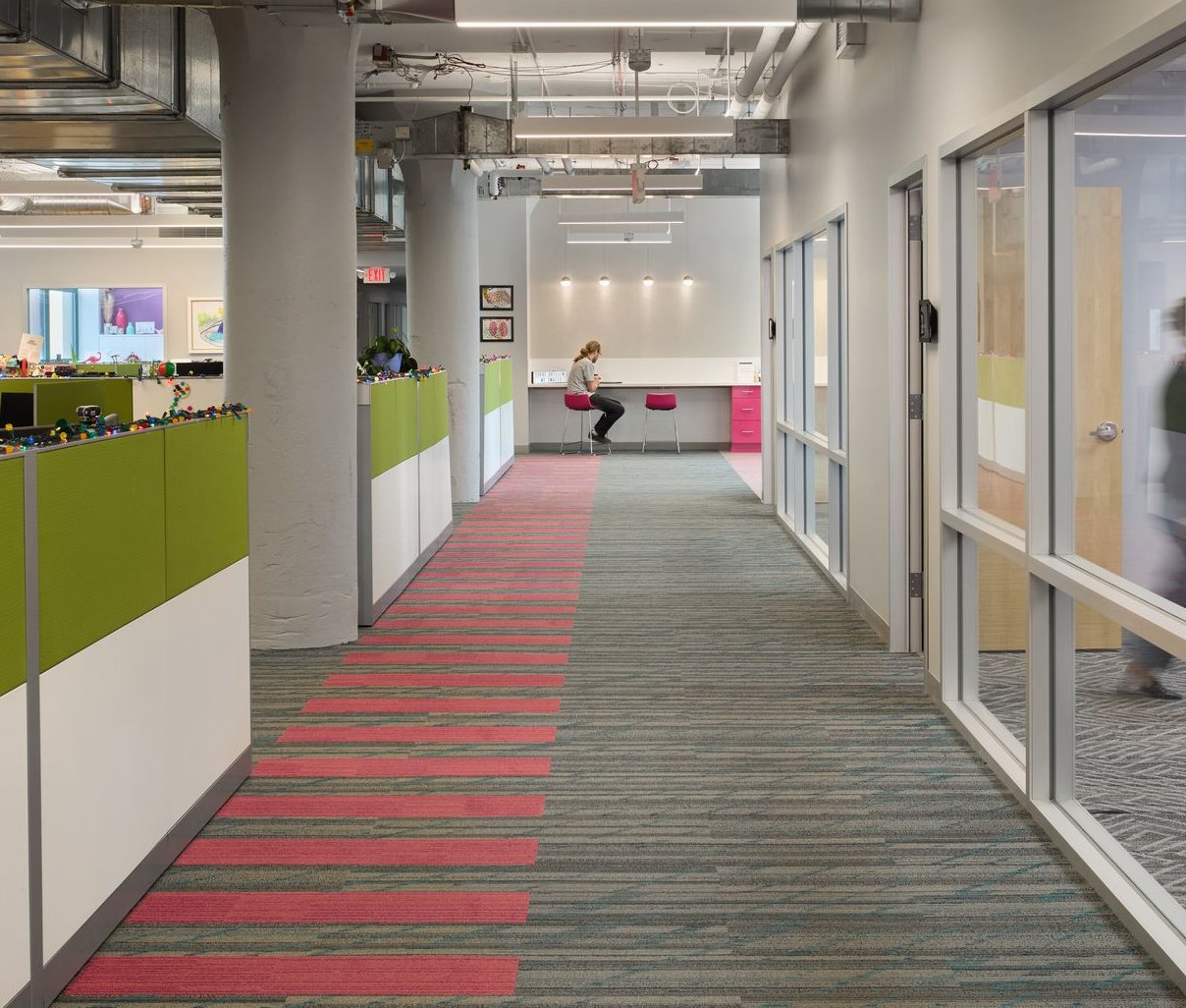 An office with cubicles and a sign that says fit technologies
