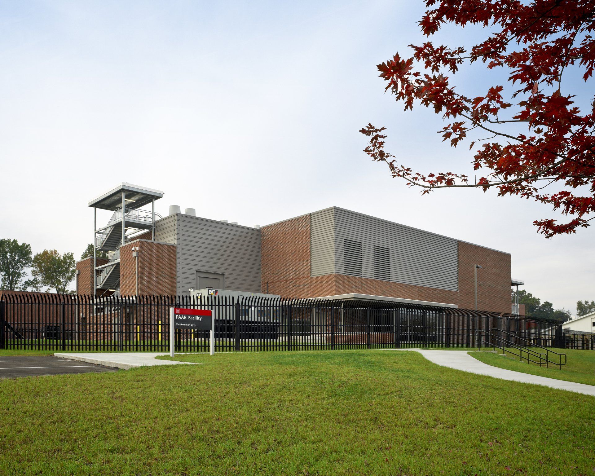 A large brick building with a fence around it