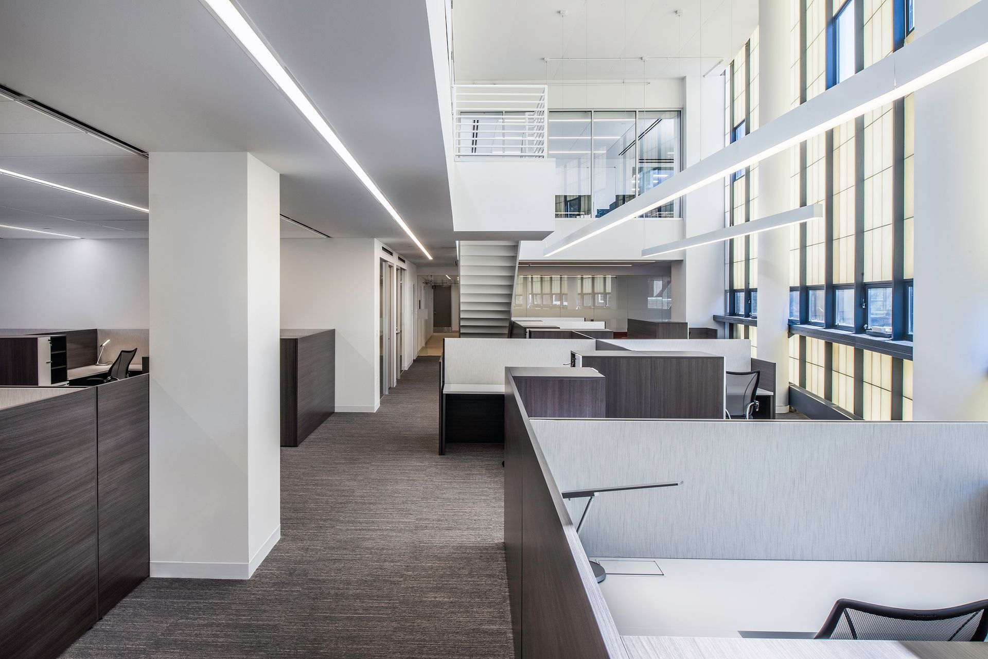 A large office building with a lot of windows and cubicles.