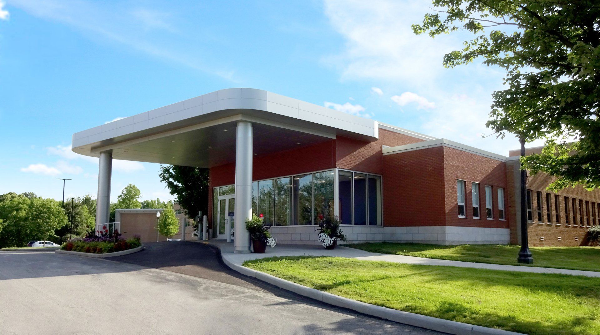 A large brick building with a white awning over the entrance.