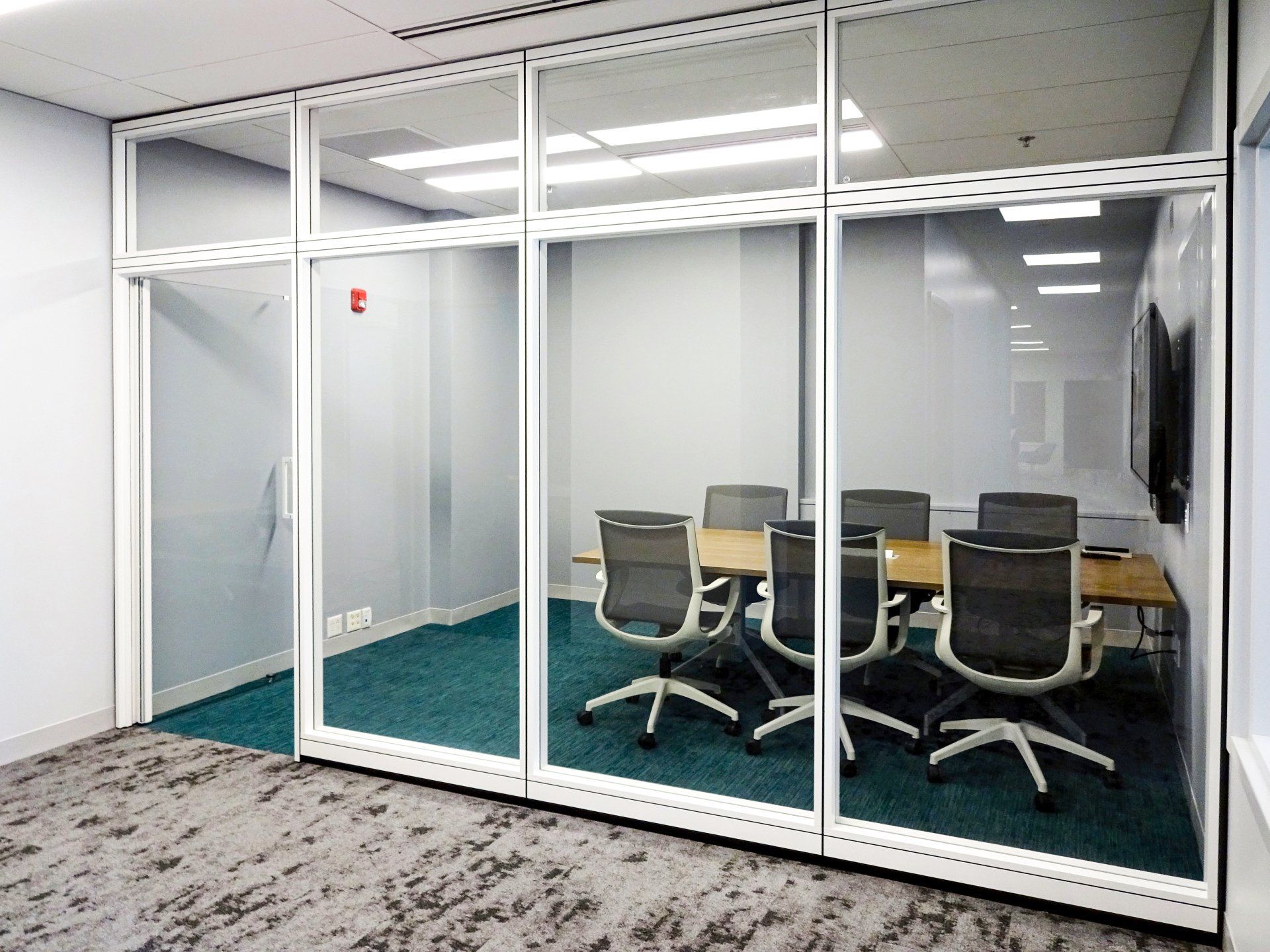 A conference room with a table and chairs in it.