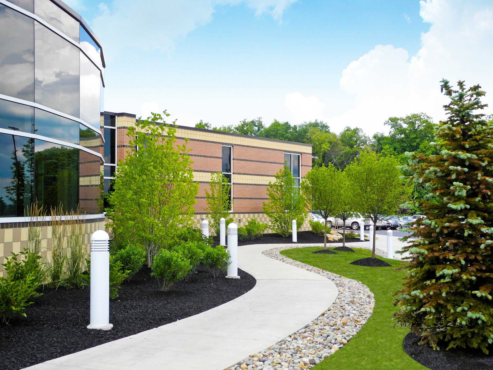 A walkway leading to a building with a lot of windows