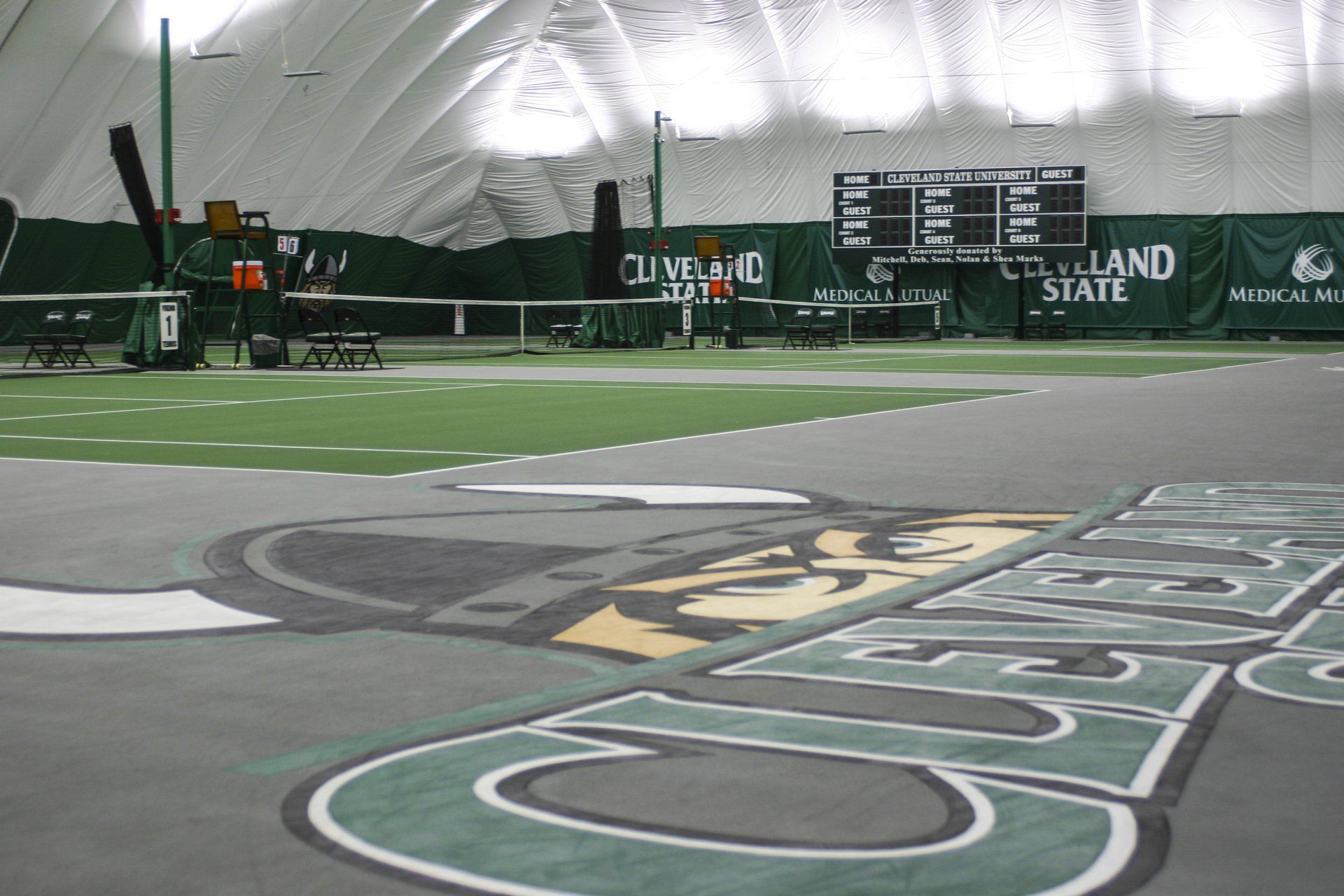 A football field with a cleveland state sign on the side
