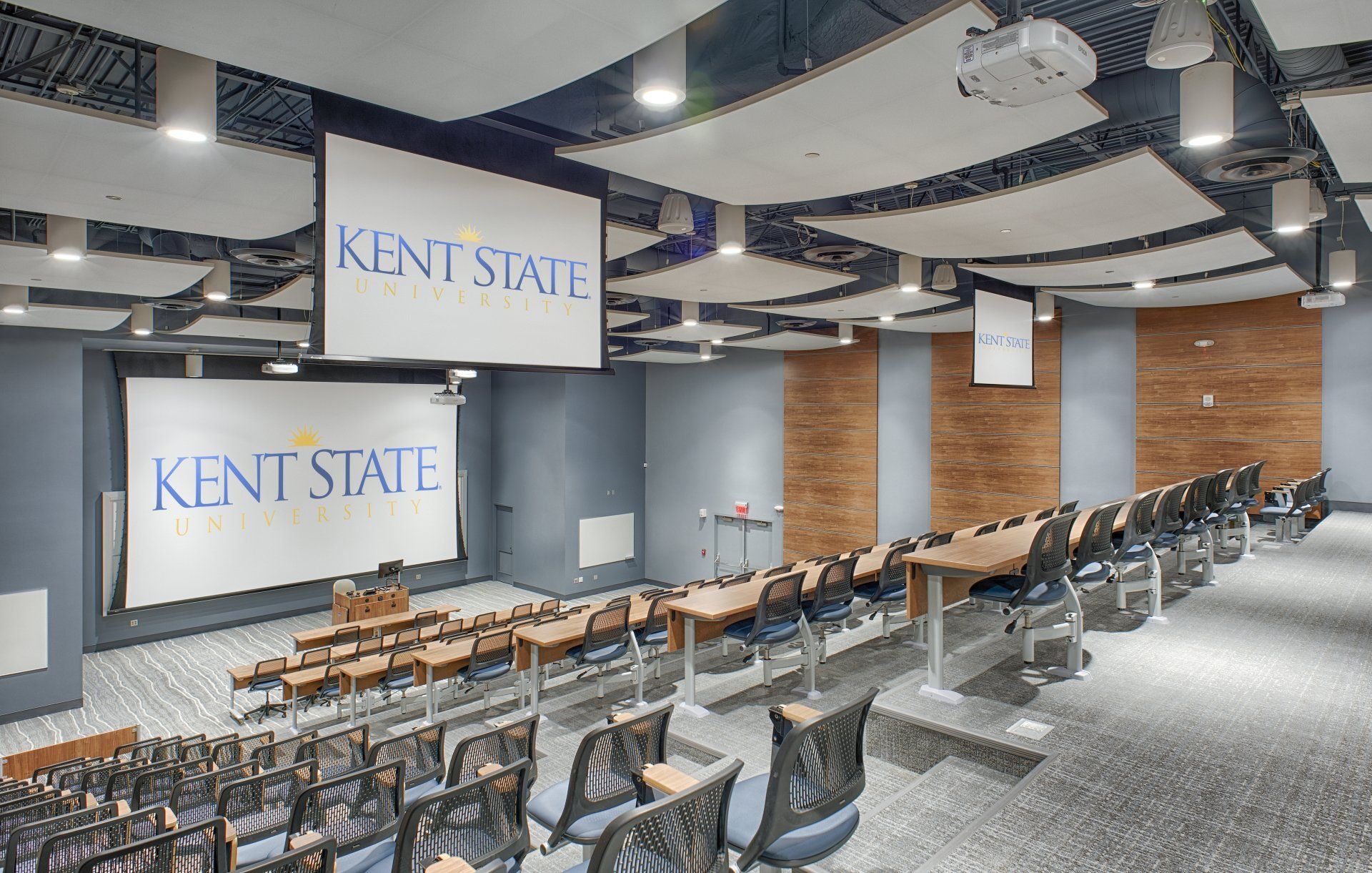 A large auditorium with a large screen that says kent state