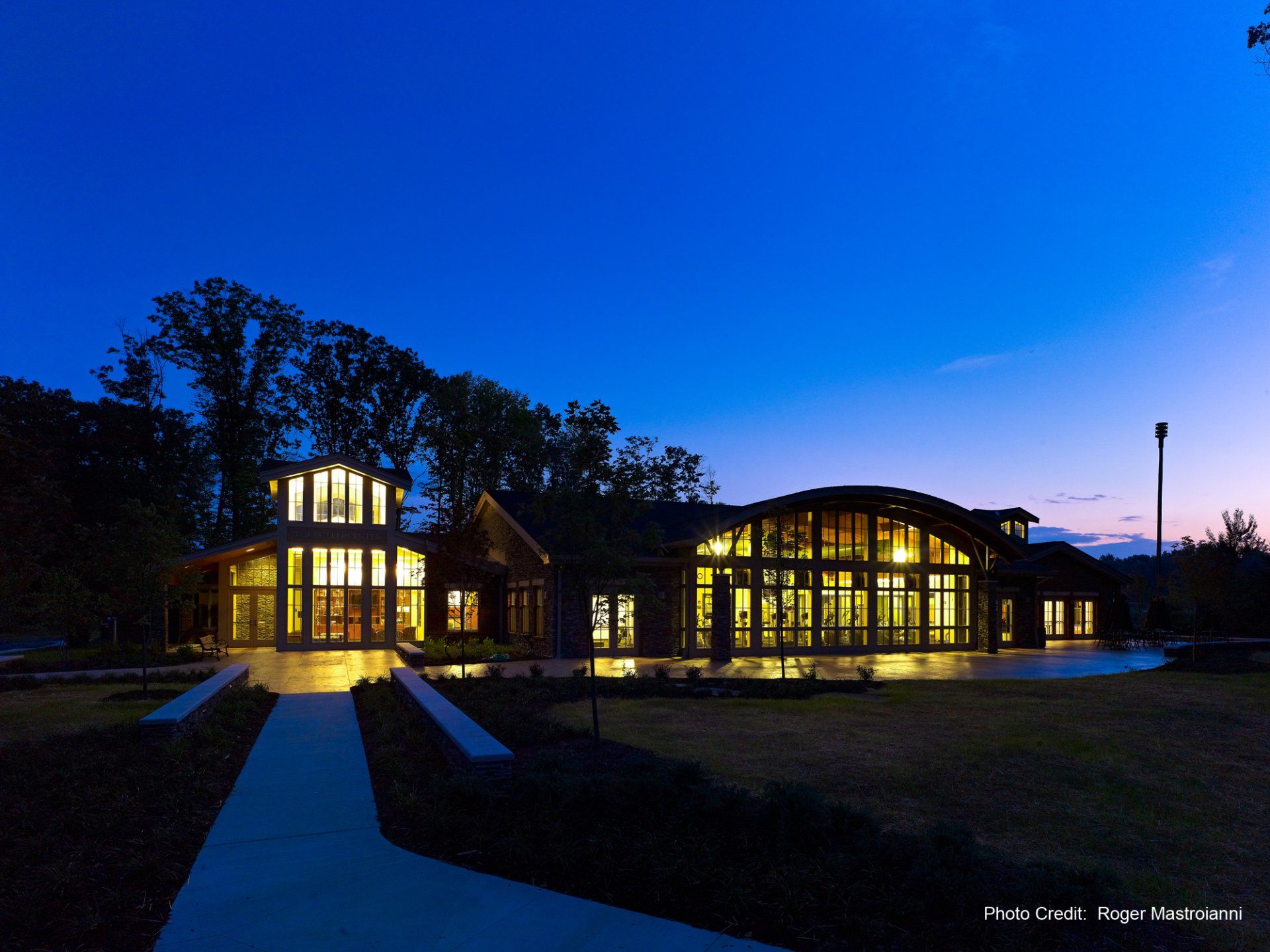 A large building with a lot of windows is lit up at night