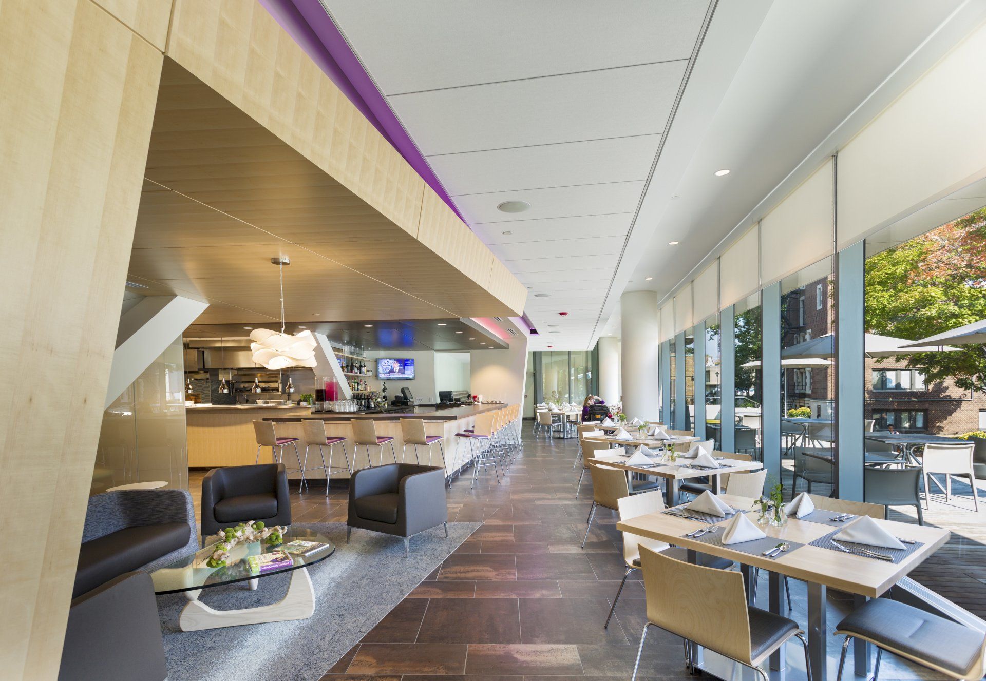 A restaurant with tables and chairs and a large window