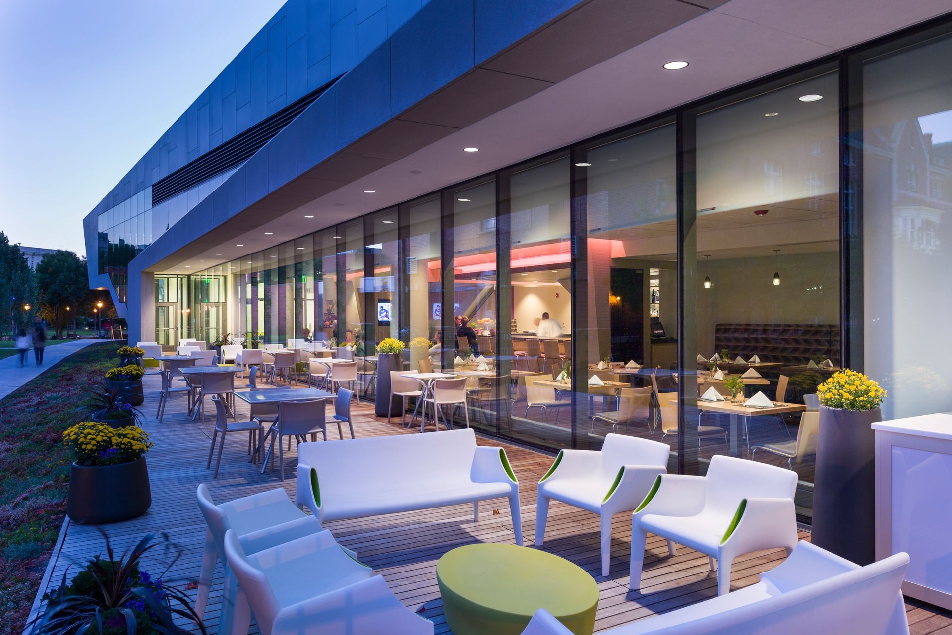 A restaurant with tables and chairs outside of it